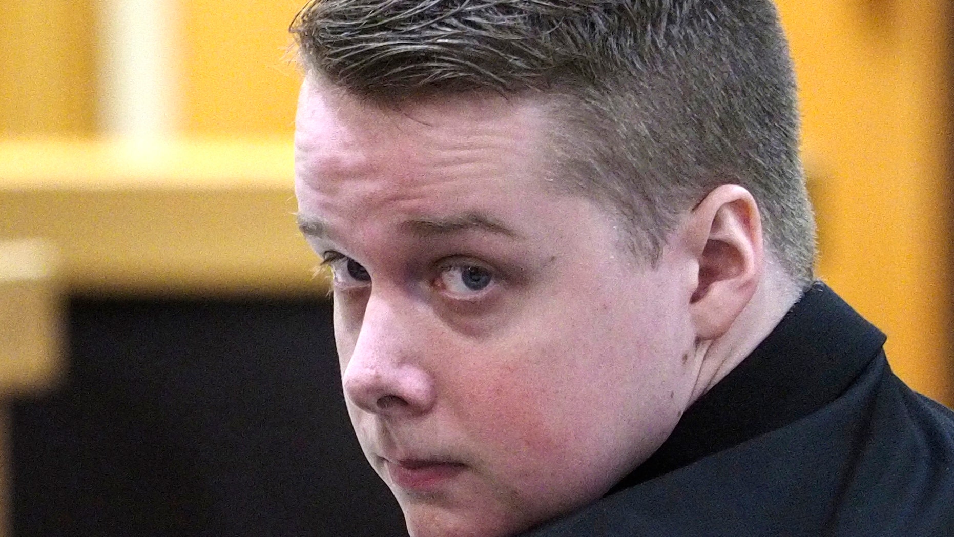   Accused Liam McAtasney looks to his family's tribune on Tuesday, February 5, 2019, at his trial for murder at Monmouth County Court in Freehold, NJ McAtasney is accused of killing Sarah Stern in December 2016. (Patti Sapone / NJ Advance Media via AP, Pool) 
