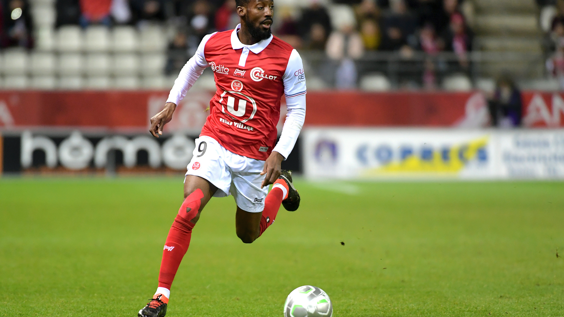 FILE - In this March 9, 2018, file photo, Reims' Anatole Ngamukol controls the ball during a league II soccer match against Chateauroux in Reims, eastern France. French soccer players are turning to the courts to fight workplace bullying and the practice known in France by an English word, "le loft." (AP Photo/Christian Lantenois, File)