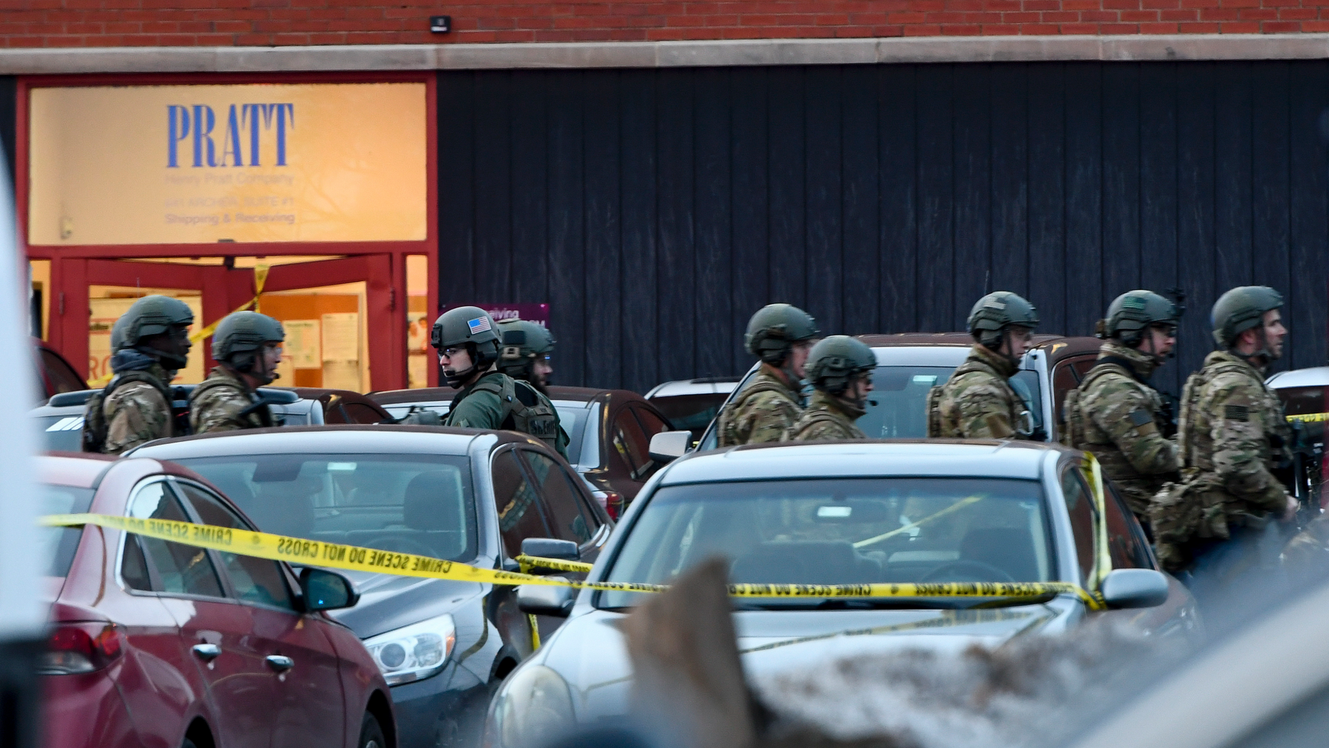 Law enforcement officers gather outside the Henry Pratt Co. manufacturing plant Friday, Feb. 15, 2019, in Aurora, Ill. Police say a gunman killed several people and injured police officers before he was fatally shot. (AP Photo/Matt Marton)