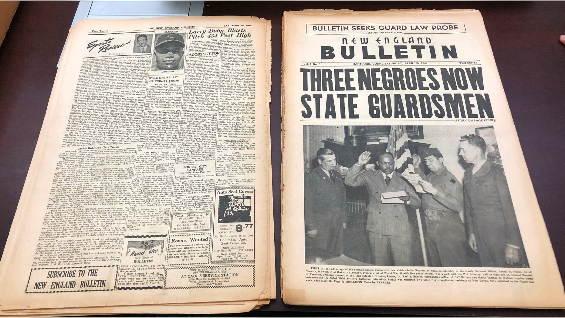 This Nov. 29, 2018 photo shows an original April 23, 1949 copy of the New England Bulletin, a black-owned and operated weekly newspaper in Hartford, Conn. Old microfilm of this and other incarnations of the newspaper are being digitized so they can be available online as part of the United States Newspaper Program. This issue highlights the first person to take advantage of a Connecticut law that granted blacks equal membership to the Connecticut National Guard. (AP Photo/Susan Haigh)