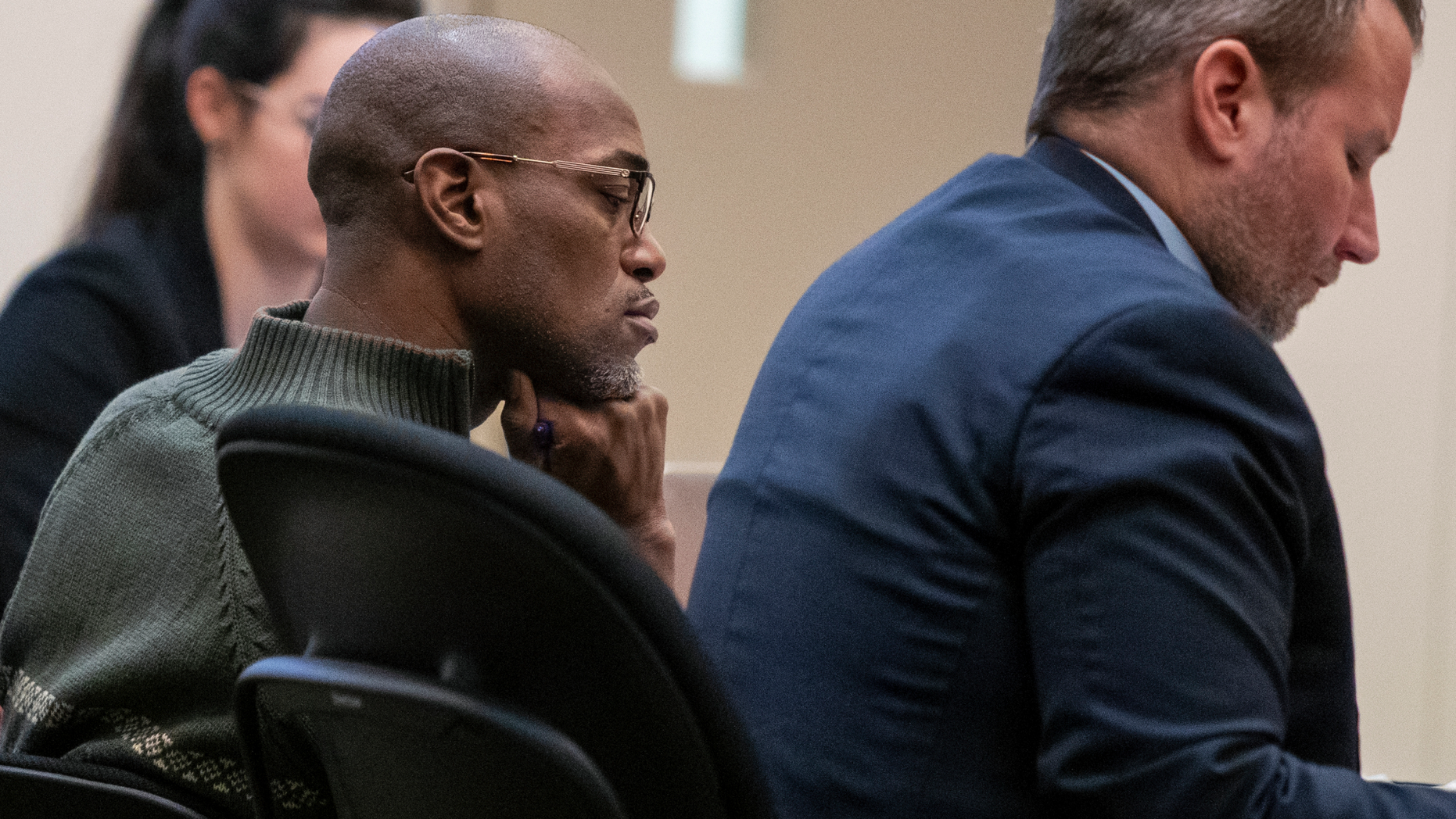 Quinn James, left, listens during Assistant Kent County Prosecutor Kellee Koncki's closing argument during his murder trial at the Kent County Courthouse in Grand Rapids on Wednesday, Feb. 27, 2019. James, accused of killing East Kentwood High student Mujey Dumbuya, 16, after she accused him of rape, is on trial this week charged with first-degree murder. (Cory Morse/The Grand Rapids Press via AP)