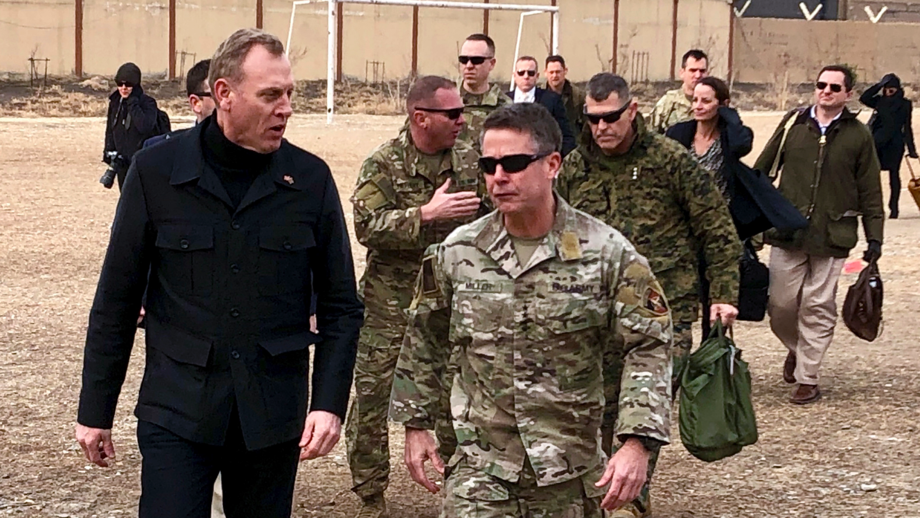 Acting Defense Secretary Pat Shanahan, left, arrives in Kabul, Afghanistan, Monday morning, Feb. 11, 2019, to consult with Army Gen. Scott Miller, right, commander of U.S. and coalition forces, and senior Afghan government leaders. The unannounced visit is the first for the acting secretary of defense, Pat Shanahan. He previously was the No. 2 official under Jim Mattis, who resigned as defense chief in December. (AP Photo/Robert Burns)