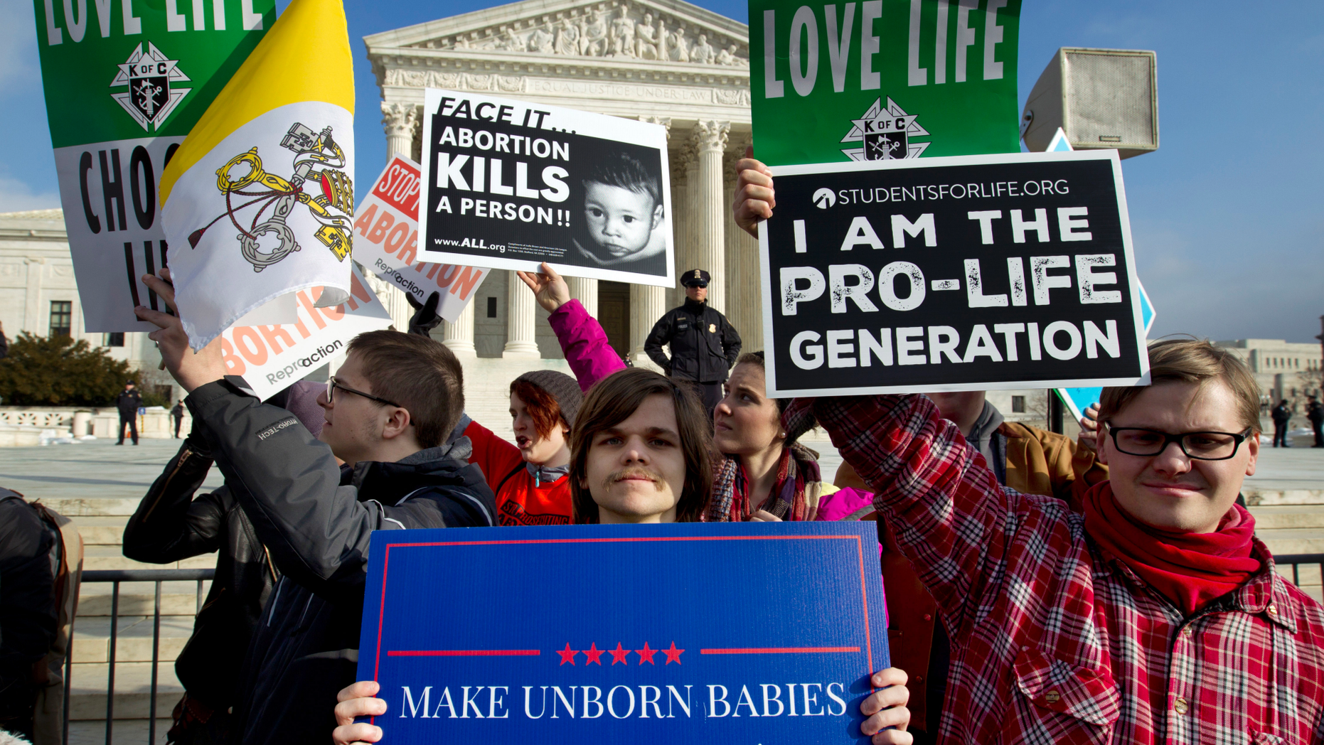 FILE - In this Friday, Jan. 18, 2019 file photo, anti-abortion activists protest outside of the U.S. Supreme Court, during the March for Life in Washington. (AP Photo/Jose Luis Magana)
