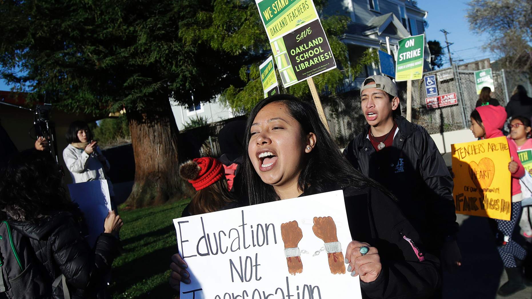 Roxana De La O Cortez, teacher at Manzanita SEED Elementary School, marches with other teachers and supporters in Oakland, Calif., Thursday, Feb. 21, 2019. Teachers in Oakland went on strike Thursday in the country's latest walkout by educators over classroom conditions and pay. (AP Photo/Jeff Chiu)