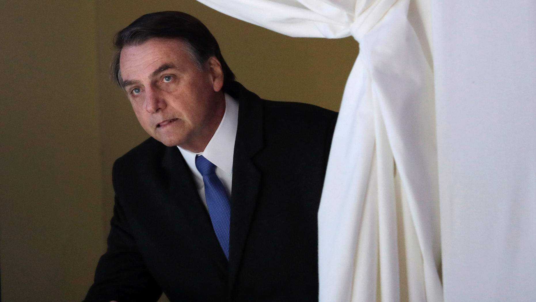 FILE - In this Jan. 22, 2019 file photo, Brazil's President Jair Bolsonaro enters the stage at the World Economic Forum, in Davos, Switzerland. Bolsonaro remains in the semi-intensive unit of a hospital in Sao Paulo with signs of a possible pneumonia infection, the Albert Einstein Hospital said in a statement Thursday, Feb. 7, 2019. (AP Photo/Markus Schreiber, File)