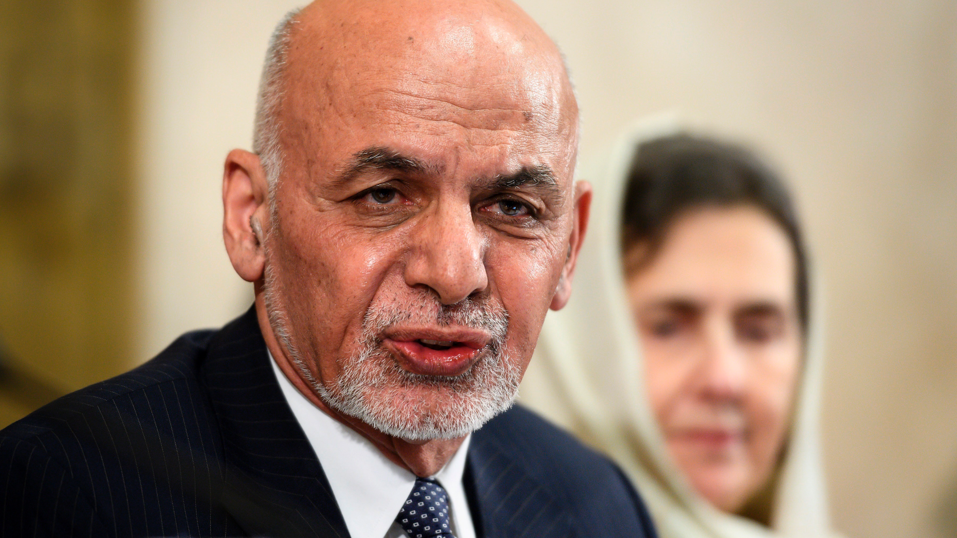 FILE - In this Nov. 28, 2018 file photo, Afghan president Ashraf Ghani delivers a speech during the United Nations Conference on Afghanistan at the UN Offices in Geneva, Switzerland. Ghani says the Taliban are welcome to set up a political office in the Kabul but that his government must be included in any peace talks. In a speech Monday, Feb. 11, 2019, he rejected the idea of an interim government, which has been embraced by the Taliban and some opposition figures, vowing that elections will he held as planned later this year. (Fabrice Coffrini/pool photo via AP, File)