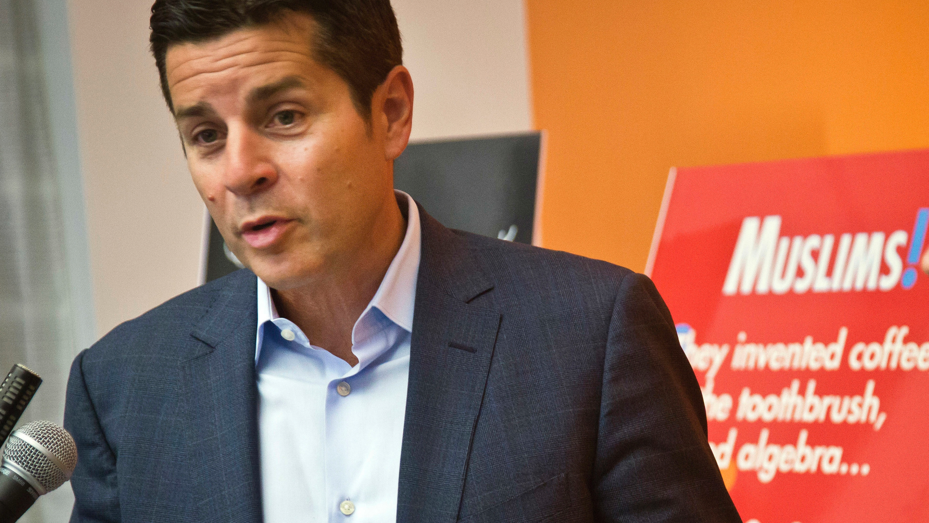 FILE - In this June 25, 2015, file photo, Muslim comedian Dean Obeidallah speaks at a news conference in New York. The radio host is asking a federal court in Ohio to award him more than $1 million in damages for his claims that a neo-Nazi website operator falsely accused him of terrorism. Attorneys for Obeidallah said in a court filing Friday, Feb. 22, 2019, that they are seeking $250,000 in compensatory damages and $1 million in punitive damages from The Daily Stormer founder Andrew Anglin and his company. Anglin hasn't formally responded to the suit. (AP Photo/Bebeto Matthews, File)