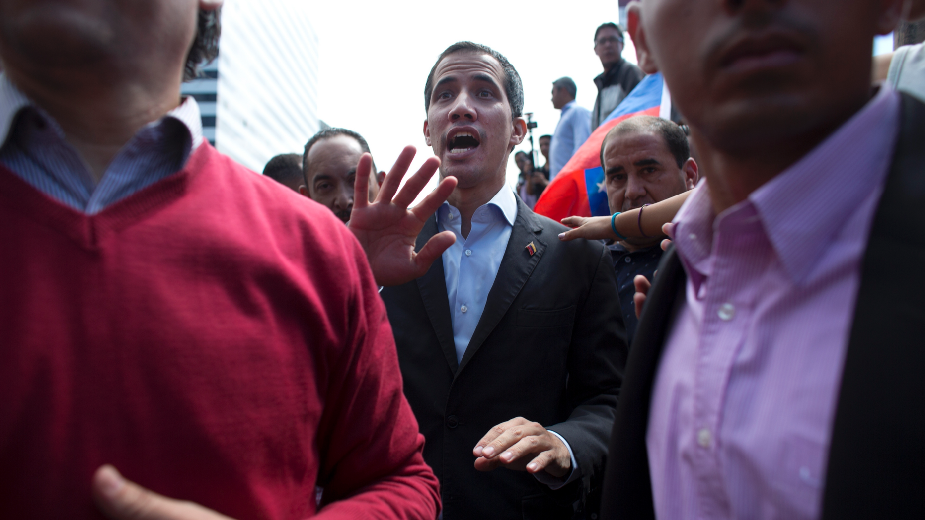 CORRECTS SPELLING OF GUAIDO - Venezuela's self-proclaimed interim president Juan Guaido walks into the crowd after he addressed transportation workers during a demonstration of support for him in Caracas, Venezuela, Wednesday, Feb. 20, 2019. Venezuela is gripped by a historic political and economic crisis despite having the world’s largest proven oil reserves. (AP Photo/Ariana Cubillos)