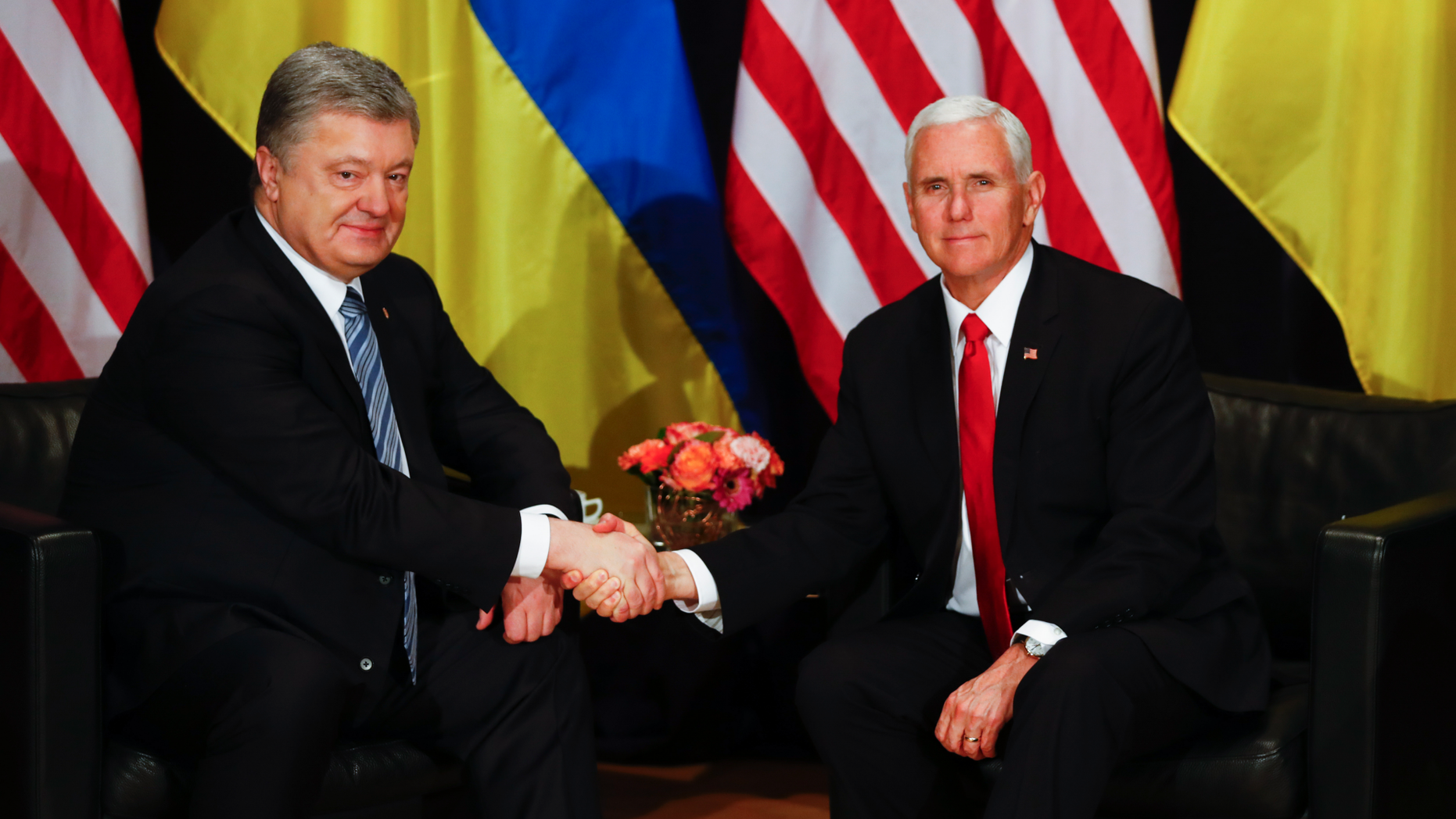 United States Vice President Mike Pence, right, and Ukrainian President Petro Poroshenko, left, shake hands during a bilateral meeting at the Munich Security Conference in Munich, Germany, Saturday, Feb. 16, 2019. (AP Photo/Matthias Schrader)