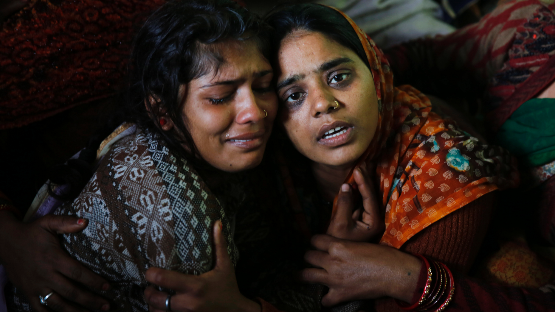 Sanju, right, and Sanjana, wife and sister respectively of paramilitary soldier Mahesh Yadav, who was killed in Thursday's explosion in Kashmir, mourn at their home in Tudihar, some 56 kilometers east of Prayagraj, Uttar Pradesh state, India, Saturday, Feb. 16, 2019. The death toll from a car bombing on a paramilitary convoy in Indian-controlled Kashmir has climbed to at least 40, becoming the single deadliest attack in the divided region's volatile history, security officials said Friday. (AP Photo/ Rajesh Kumar Singh)