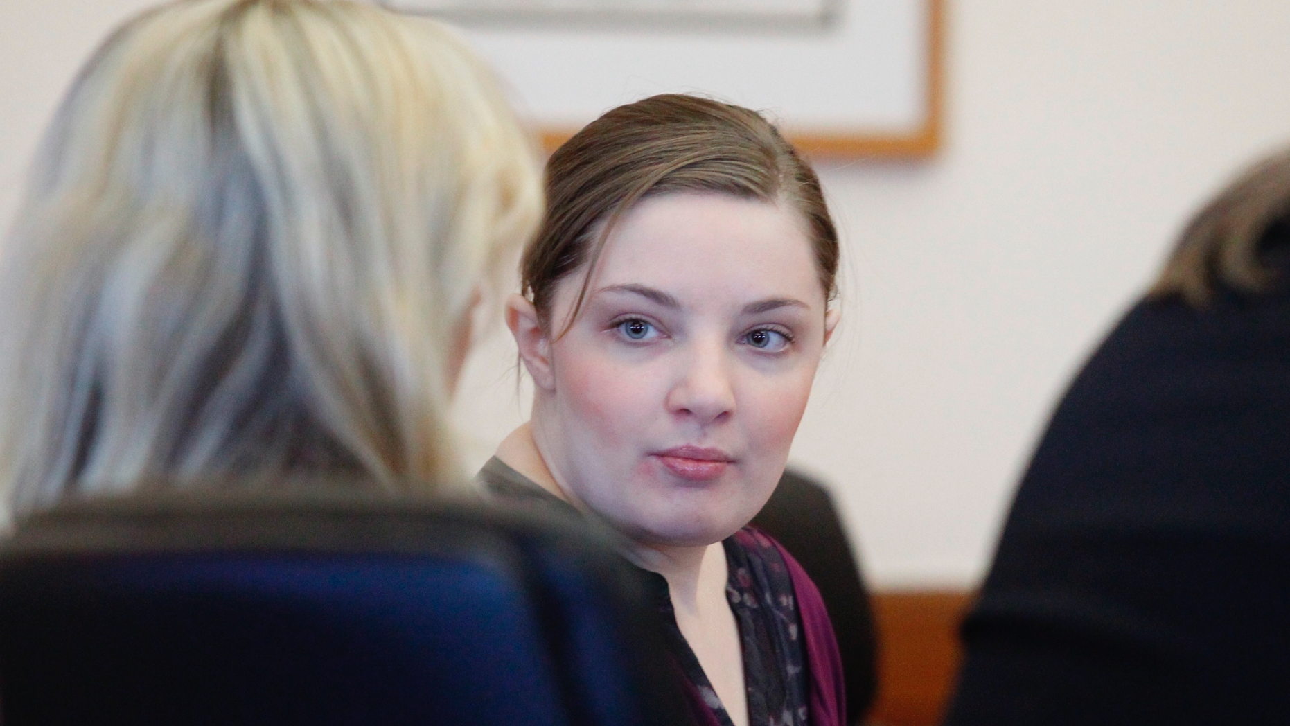 Cheyanne Harris talks with her attorney during her court appearance on Wednesday, Jan. 30, 2019 in Le Mars, Iowa. Harris, the mother of a baby whose lifeless body was found in an infant swing wearing a maggot-infested diaper is standing trial in his death. Court records say Harris has pleaded not guilty to first-degree murder and child endangerment resulting in death. The trial was moved to Le Mars in Plymouth County from Chickasaw County because of publicity. (Jeff Reinitz/The Courier via AP)
