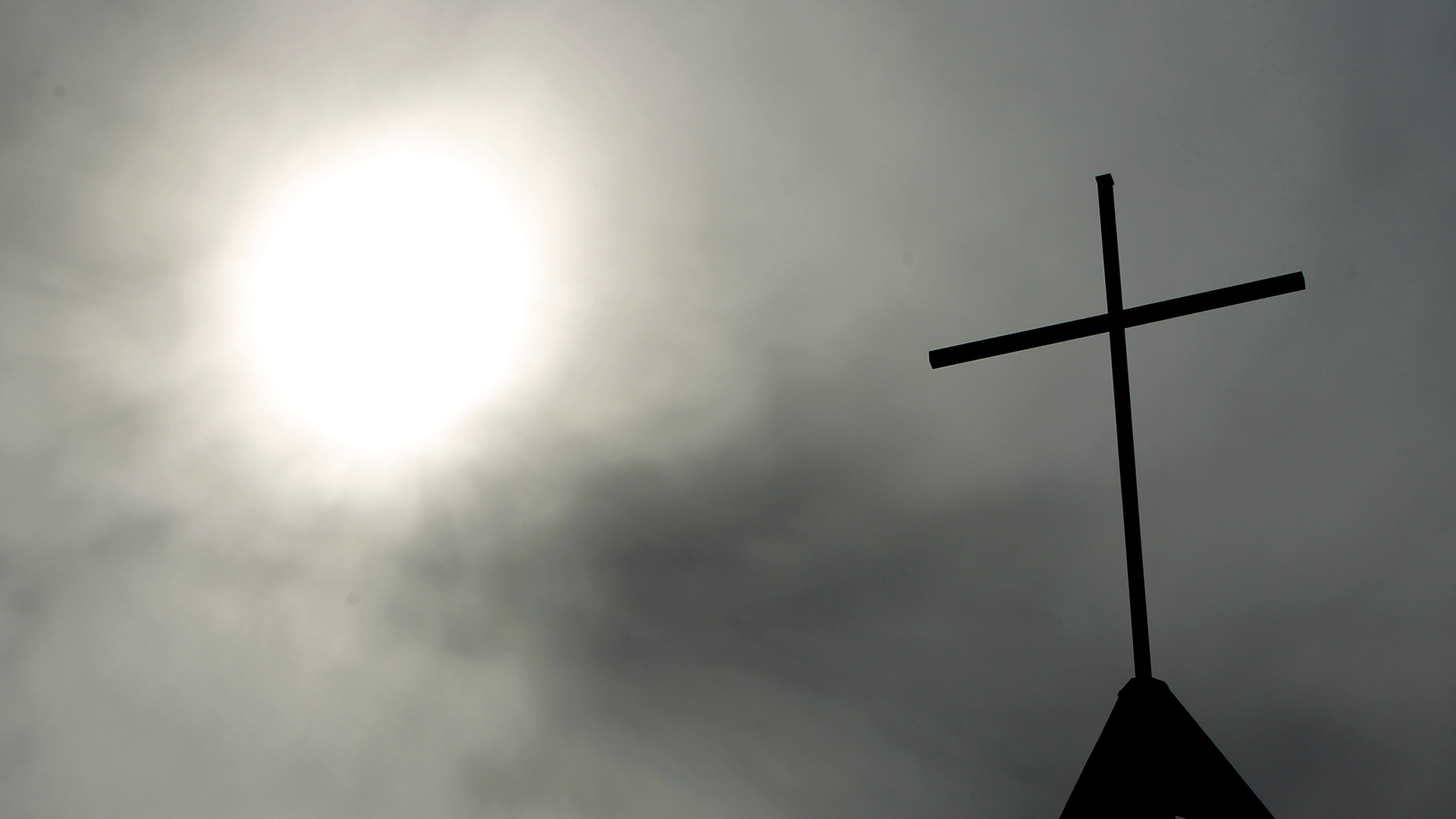 A cross sits on top of a church in Berlin, Germany. Pope Francis' high-stakes sex abuse prevention summit is meant to call attention to the crisis as a global problem that requires a global response. (AP Photo/Markus Schreiber, File)