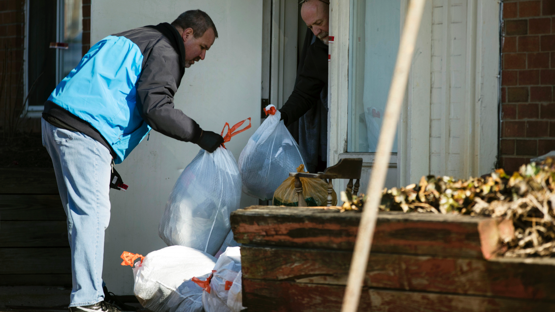 Investigators remove bags from a crime scene at the Robert Morris apartments in Morrisville, Pennsylvania, on Tuesday, February 26, 2019. A Pennsylvania woman charged with her teenage daughter for the deaths of several parents including children, has been brought to justice for murder charges. The bodies were found Monday in an apartment complex. (AP Photo / Matt Rourke)
