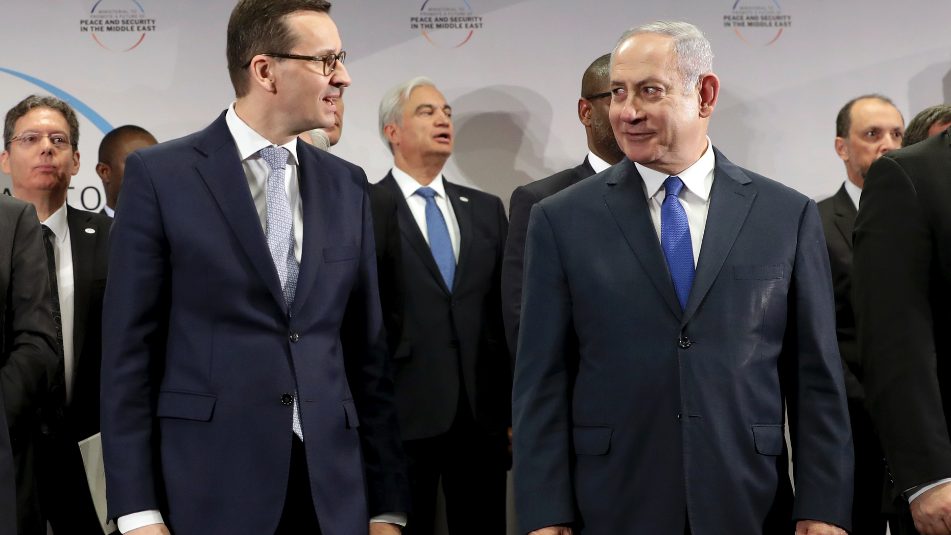 File -- In this Thursday, Feb. 14, 2019 photo Poland's Prime Minister Mateusz Morawiecki, left, and Israeli Prime Minister Benjamin Netanyahu, right, attend a group photo during a meeting in Warsaw, Poland. Poland's prime minister canceled plans for his country to send a delegation to meeting in Jerusalem on Monday after the acting Israeli foreign minister Israel Katz said that Poles "collaborated with the Nazis" and "sucked anti-Semitism from their mothers' milk". (AP Photo/Michael Sohn)