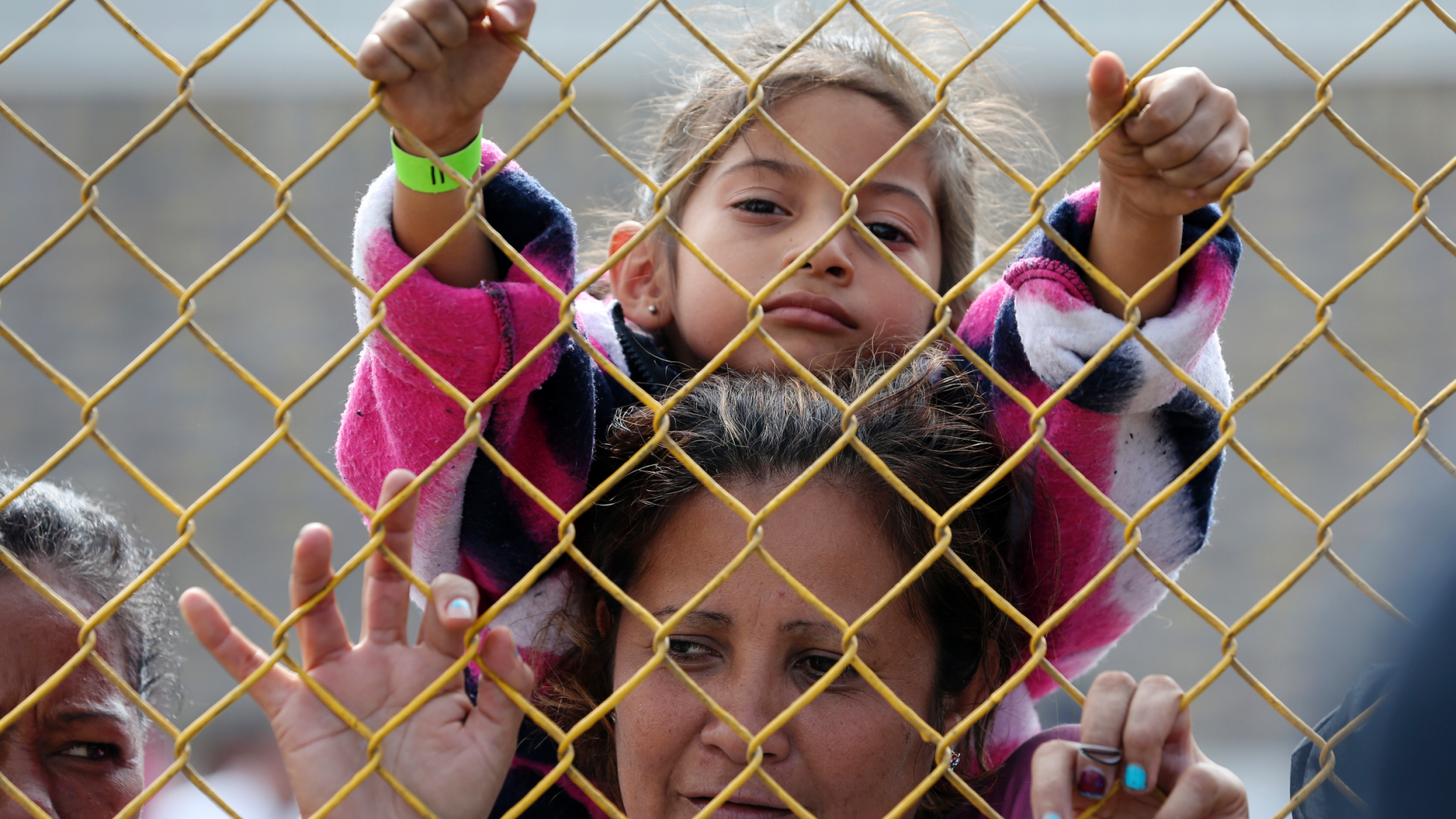 Six-year-old Daniela Fernanda Portillo Burgos sits on the shoulders of her mother, Iris Jamilet, 39, as they look out through the fence of a immigrant shelter in Piedras Negras, Mexico, Tuesday, Feb. 5, 2019. A caravan of about 1,600 Central American migrants camped Tuesday in the Mexican border city of Piedras Negras, just west of Eagle Pass, Texas. The governor of the northern state of Coahuila described the migrants as