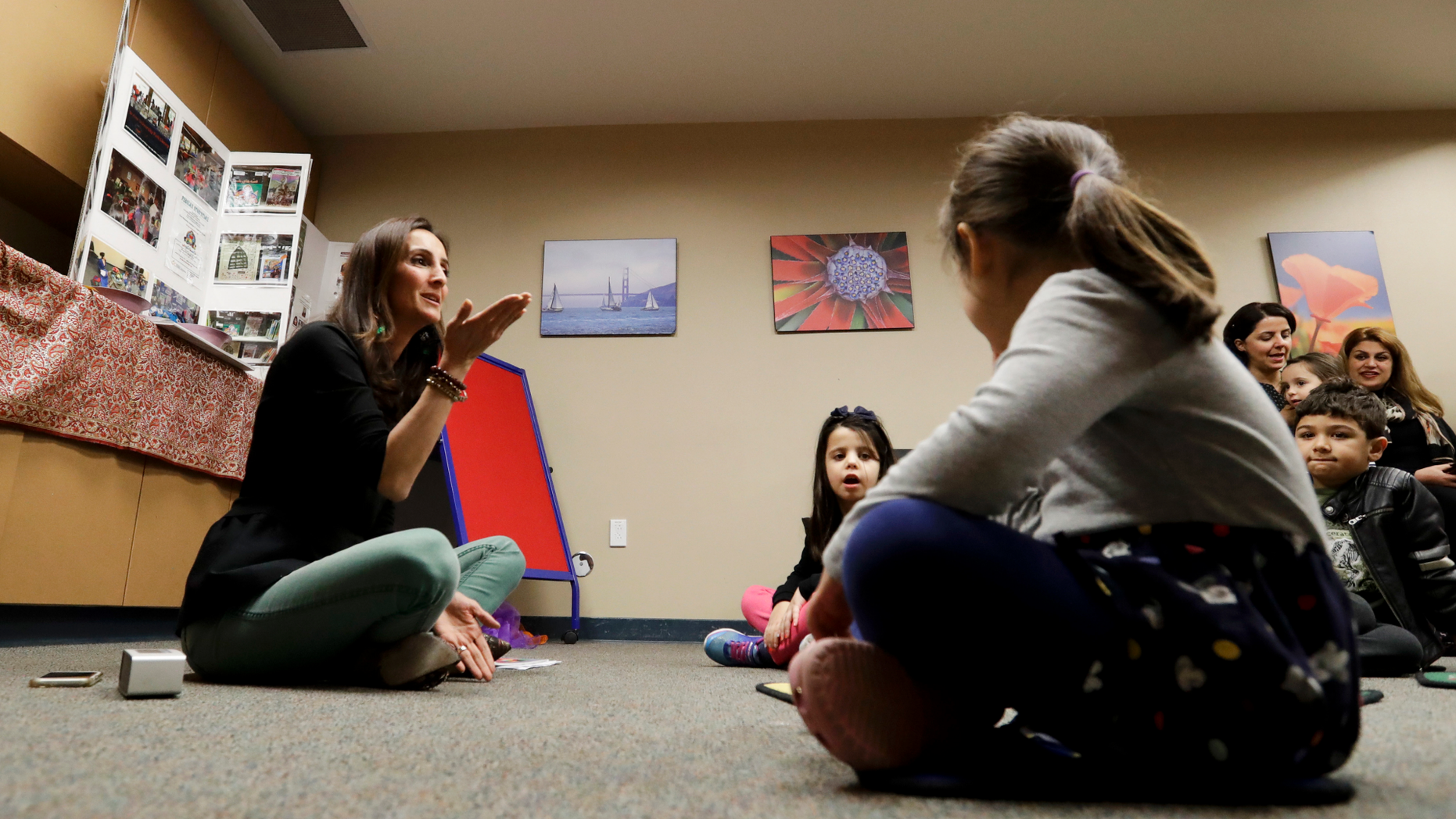 In this Jan. 23, 2019, photo, Bahareh Hedyahe leads Persian story time at Irvine public library in Irvine, Calif. It's been four decades since the Iranian revolution overthrew the ruling shah, prompting tens of thousands of Iranian exiles and refugees to make their lives in the United States. Years later, they have set down roots here and are finding ways to pass their love of Iranian culture to their American children and grandchildren. (AP Photo/Chris Carlson)