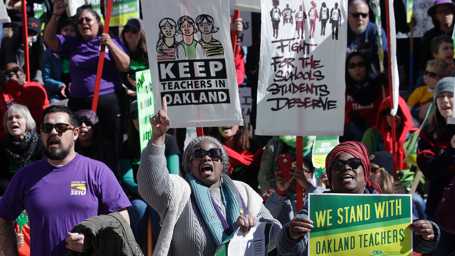 FILE - In this Thursday, Feb. 21, 2019 file photo, teachers, students and supporters rally at Frank Ogawa Plaza in front of City Hall in Oakland, Calif. Teachers in Oakland are preparing to strike for a third day after negotiations with the school district broke down over the weekend. (AP Photo/Jeff Chiu, File)