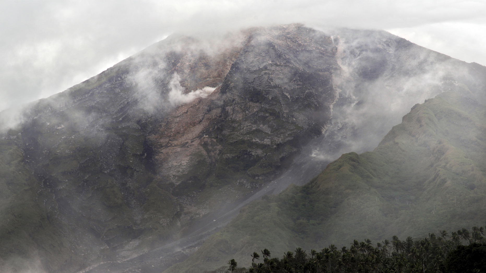 Mount Karangetang is partially covered by volcanic smoke as it spews on Siau Island, North Sulawesi, Indonesia, Thursday, Feb. 7, 2019. The 1,784-meter (5,853-foot) volcano, which currently is on its second-highest alert level, started erupting and spitting clouds of gas and lava on Sunday. (AP Photo)