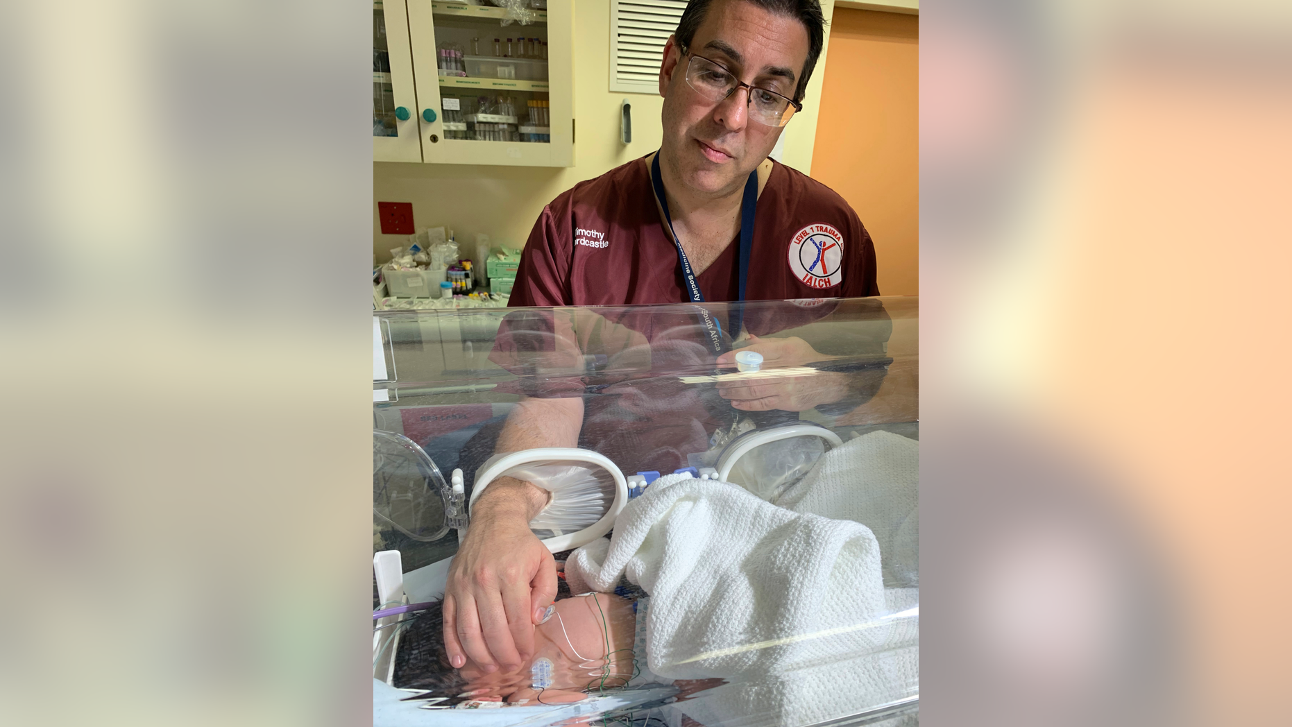 Doctor Timothy Hardcastle treats a baby in hospital after she was rescued from a storm water pipe in Durban, South Africa, Monday, Feb. 11, 2019. The newborn, believed to be between one and three days old, was rescued after a three-hour rescue mission.