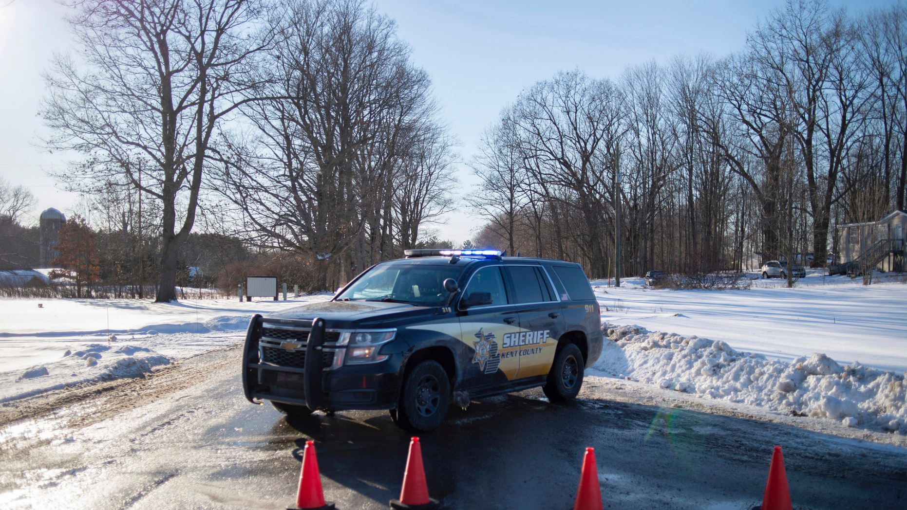 Members of the Kent County Sheriff investigate the scene of a deadly shootout at the corner of 19 Mile NE and NE Division Division on a property on Monday, February 18, 2019, near Cedar Springs, Michigan. WOOD-TV reports Kent County Sheriff Michelle LaJoye- According to Young, the authorities found the victims at a property near Cedar Springs, a community about 30 kilometers north of Grand Rapids. (Neil Blake / MLive.com / The Grand Rapids Press via AP)