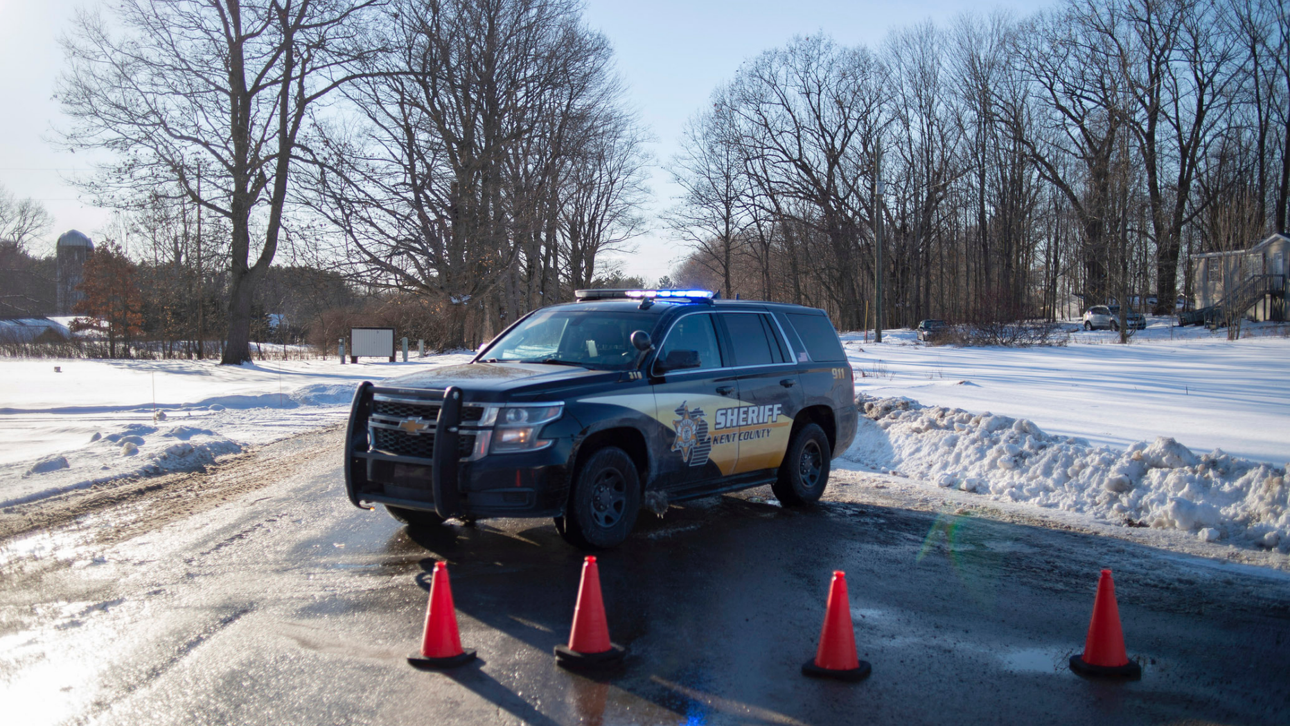 Kent County Sheriff personnel investigate the scene of a fatal shooting near the corner of 19 Mile NE and Division Avenue NE at a property on Monday, Feb. 18, 2019, near Cedar Springs, Mich. WOOD-TV reports Kent County Sheriff Michelle LaJoye-Young says authorities discovered the victims at a property near Cedar Springs, a community about 30 miles north of Grand Rapids. (Neil Blake/MLive.com/The Grand Rapids Press via AP)