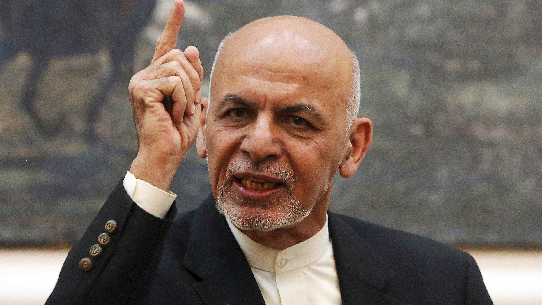FILE - In this July 15, 2018, file photo, Afghan President Ashraf Ghani speaks during a press conference at the presidential palace in Kabul, Afghanistan. The Afghan government has fired its election commission, Tuesday, Feb. 12, 2019. The move by Ghani’s administration comes more than three months after chaotic parliamentary elections -- the results of which have still not been announced -- and ahead of July’s controversial presidential vote. (AP Photo/Rahmat Gul, File)