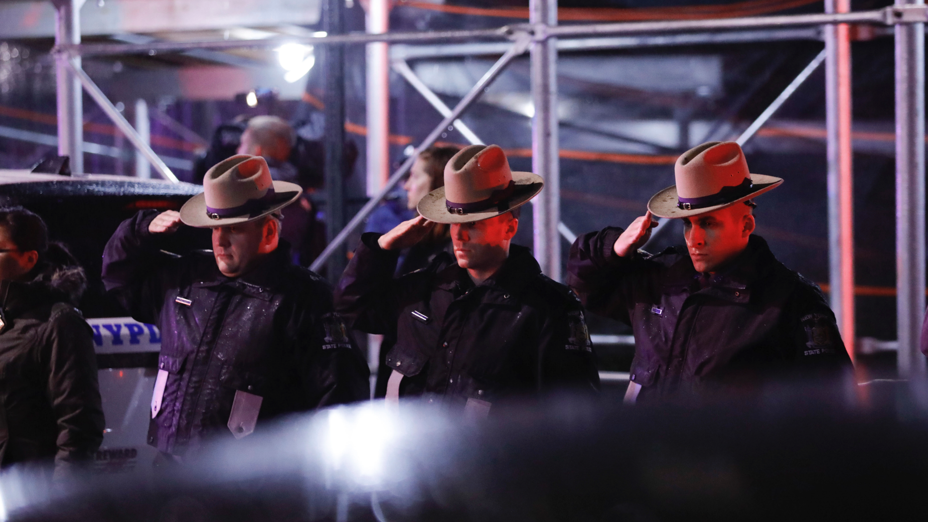 Officials greet the procession when the remains of murdered detective Brian Simonsen were moved from the Jamaican Hospital Medical Center on Tuesday, February 12, 2019, in Queens, New York. The NYPD detective and the NYPD sergeant were shot while responding to an armed robbery at a T-Mobile store in Queens. (AP Photo / Kevin Hagen)