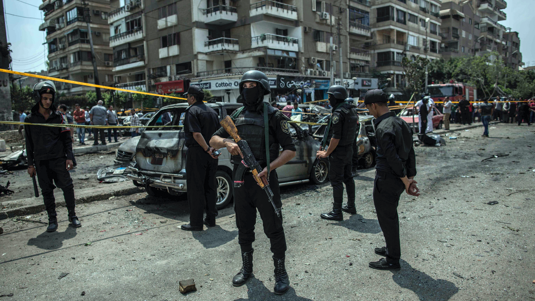 FILE -- In this June 29, 2015 file photo, Egyptian policemen stand guard at the site of a bombing that killed Egypt's top prosecutor, Hisham Barakat, who oversaw cases against thousands of Islamists, in Cairo. On Wednesday, Feb. 20, 2019 Egypt executed nine suspected Muslim Brotherhood members convicted of involvement in the 2015 assassination of Barakat, security officials said. The nine were found guilty of taking part in the bombing that killed Barakat, the first assassination of a senior official in Egypt in a quarter century. (AP Photo/Eman Helal, File)