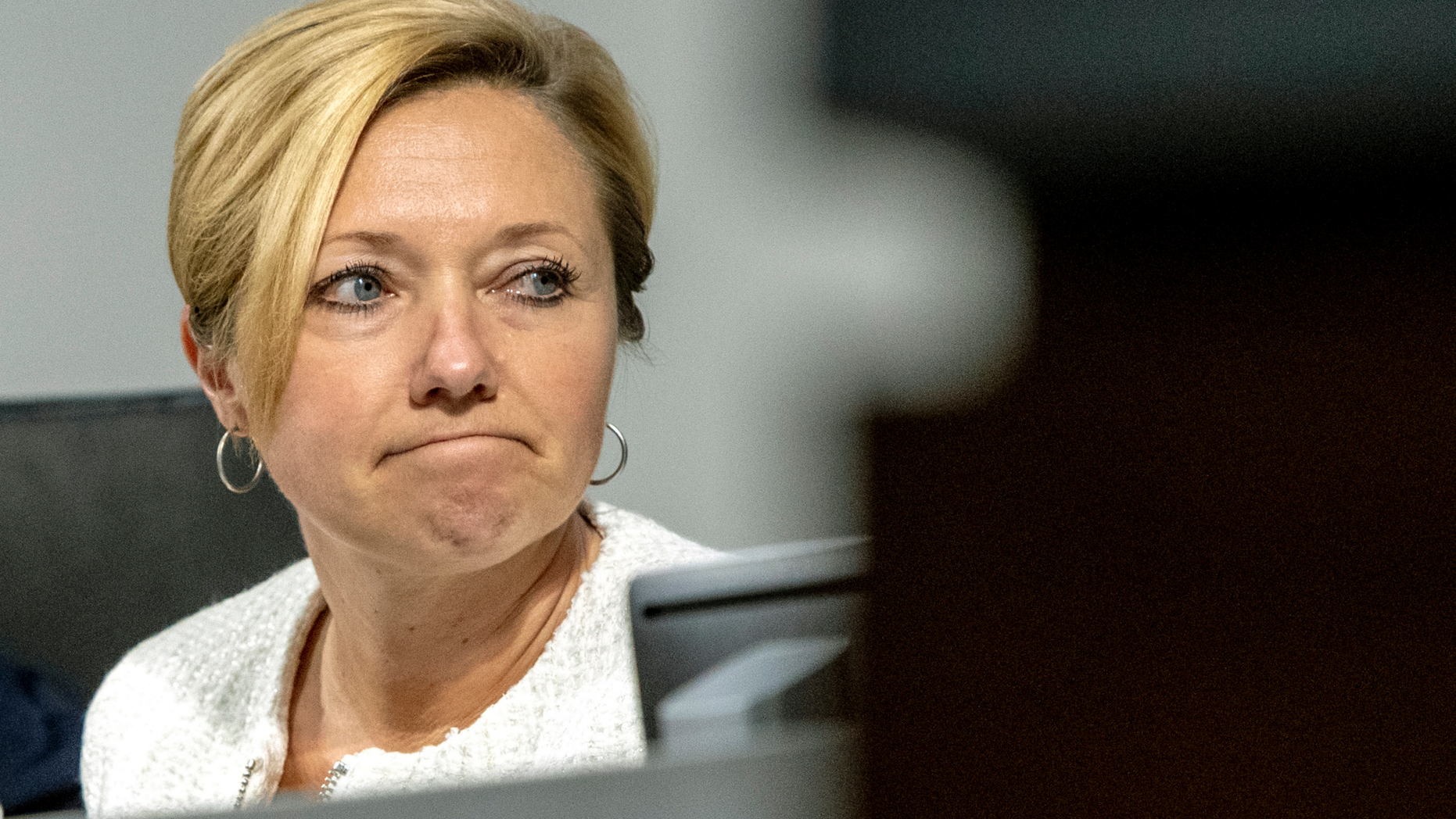 In this Tuesday, Feb. 26, 2019 photo, Mayor Rosalynn Bliss reacts to protestors during a Grand Rapids City Commission meeting in Grand Rapids, Mich. Civil rights groups allege Grand Rapids police officials acted on racial profiling not fear of terrorism when they called federal immigration authorities on a former U.S. Marine who is Latino. Jilmar Ramos-Gomez was arrested in November 2018 after setting a small fire inside Spectrum Health Butterworth Hospital and then standing on the rooftop helipad. He was later held for three days by U.S. Immigration and Customs Enforcement, even though he was arrested with a U.S. passport. Grand Rapids Interim Police Chief David Kiddle said his department acted properly. (Cory Morse/The Grand Rapids Press via AP)