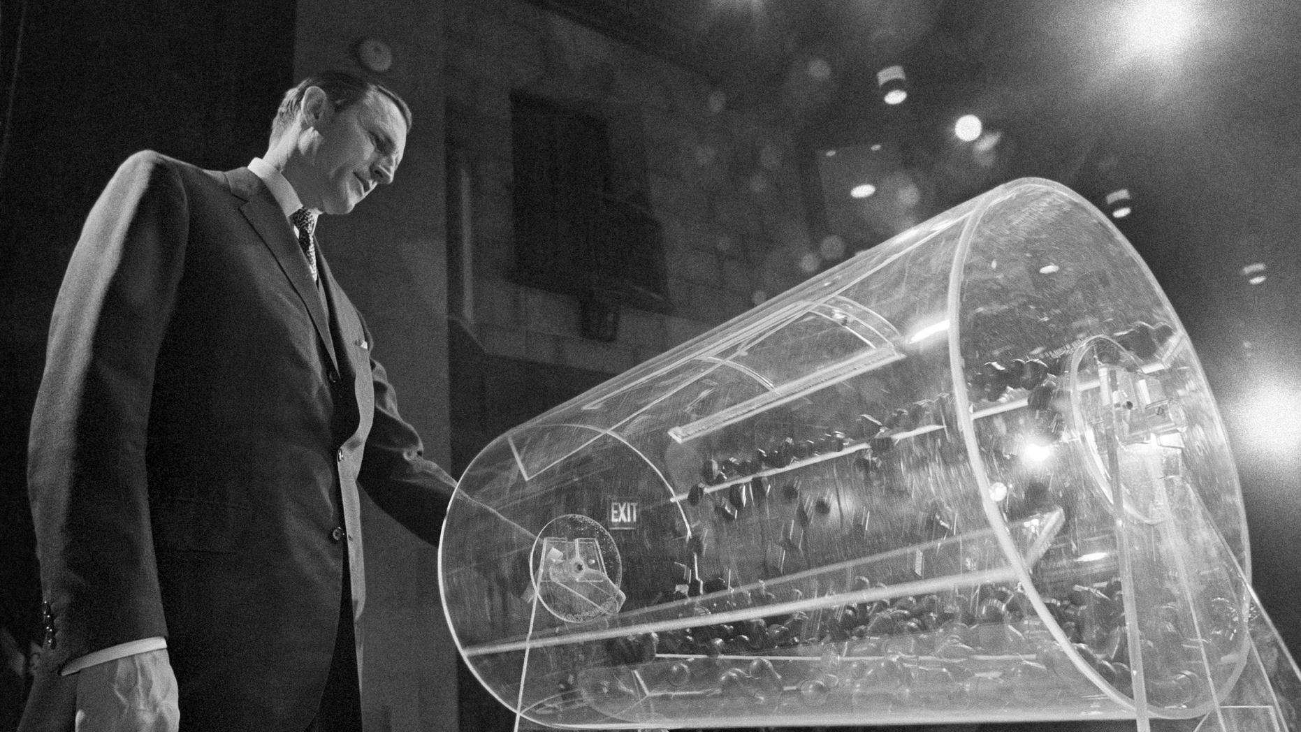 File-This Feb. 2, 1972, file photo shows Draft Director Curtis W. Tarr spinning one of the two Plexiglas drums in Washington as the fourth annual Selective Service lottery begins. The chairman of a panel considering changes to the U.S. military draft said Monday, Feb. 25, 2019, its recommendations to Congress won't be influenced by a federal judge's recent ruling that the current system is unconstitutional because it only applies to men. The military has not drafted anyone into service in more than 40 years, but American men must still register when they turn 18. Recent efforts to make registration also mandatory for women have set off intense debate in Washington. (AP Photo/Charles W. Harrity, File)