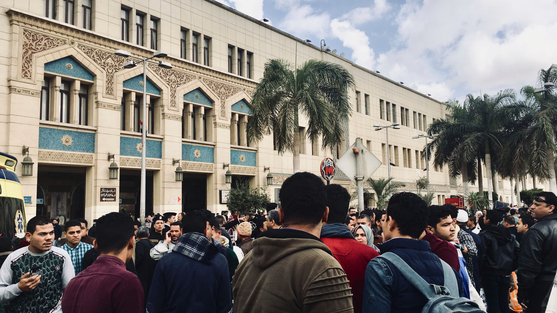 People gather outside Ramsis train station in Cairo, Egypt, Wednesday, Feb. 27, 2019. An Egyptian medical official says 20 people have been killed and dozens injured when a major fire erupted at the main train station in Cairo. Mohammed Said, the head of the Cairo Railroad hospital, says the death toll is expected to rise further following the blaze on Wednesday. (AP Photo/Nariman El-Mofty)