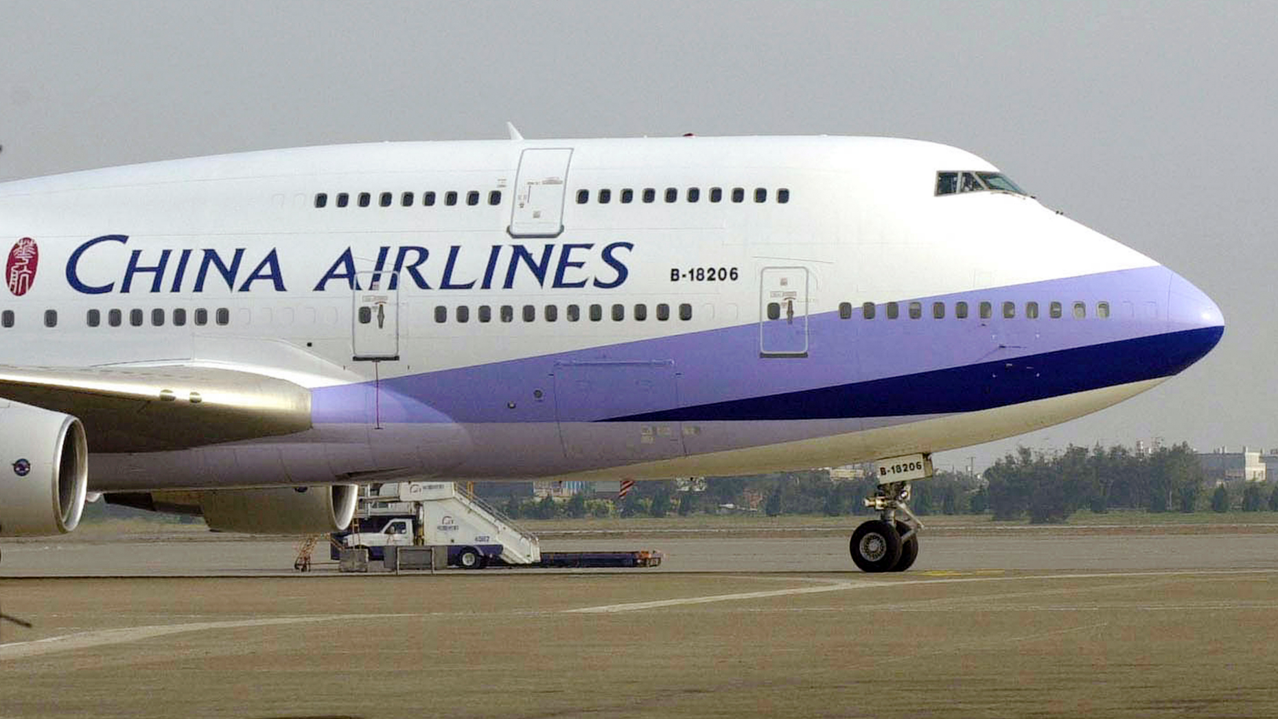 FILE - In this Jan. 26, 2003, file photo, a China Airlines Boeing 747-400 sits on the tarmac at the Chiang Kai-shek International airport in Taoyuan, Taiwan. Pilots from Taiwan's China Airlines have gone on strike during the Lunar New Year travel rush Friday, Feb. 8, 2019, in Taiwan, forcing the cancellation of 18 flights over coming days. (AP Photo/Jerome Favre, File)