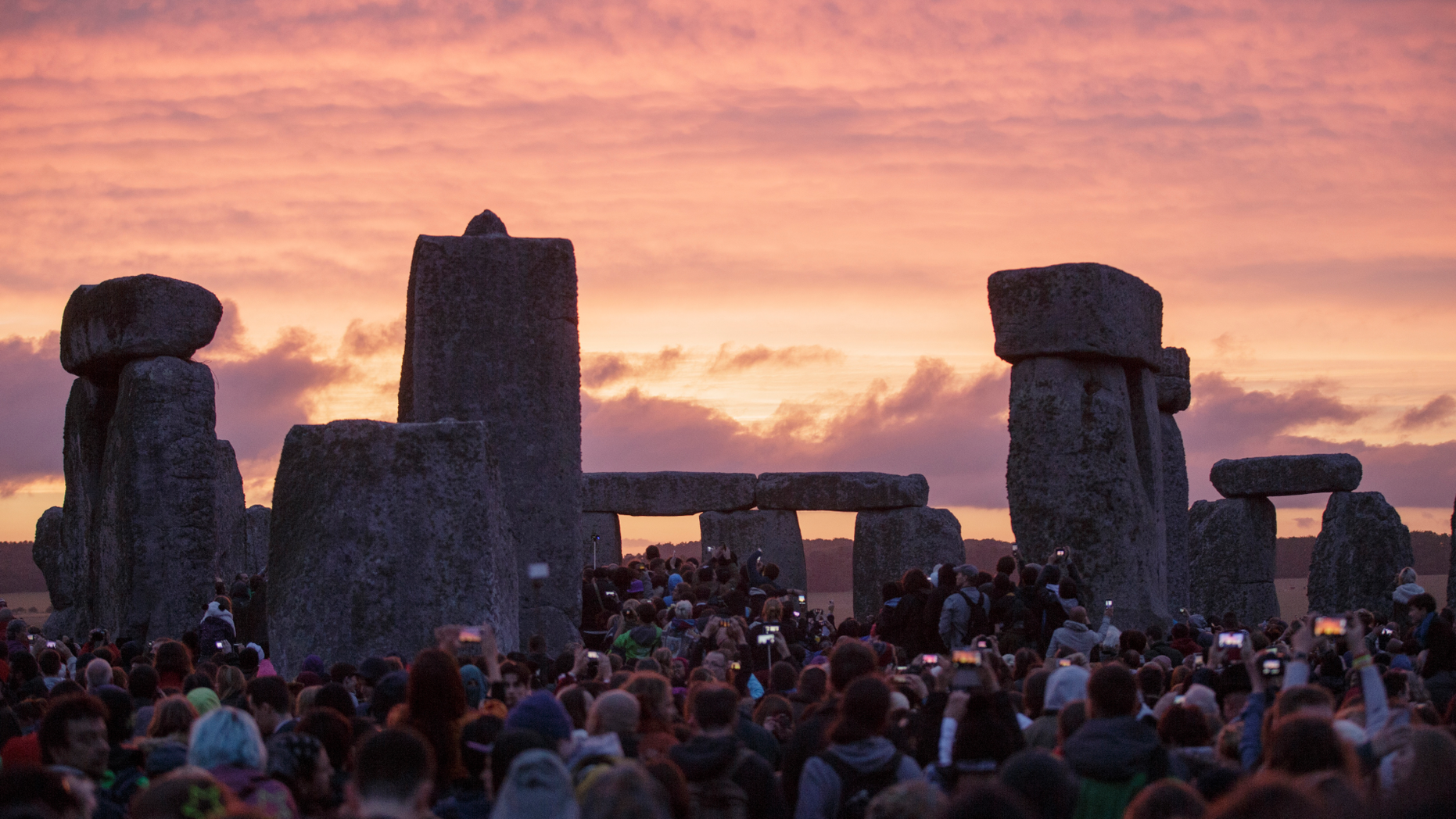FILE - In this Sunday, June 21, 2015 file photo, the sun rises as thousands of revellers gather at the ancient stone circle Stonehenge to celebrate the Summer Solstice, near Salisbury, England. A new study suggests the practice of building huge stone monuments was spread throughout ancient Europe from northwestern France. In an email Tuesday, Feb. 12 2019 Bettina Schulz Paulsson of the University of Gothenburg said the findings challenge previous theories that claimed megaliths originated in the Middle East or independently in different parts of Europe.(AP Photo/Tim Ireland, file)
