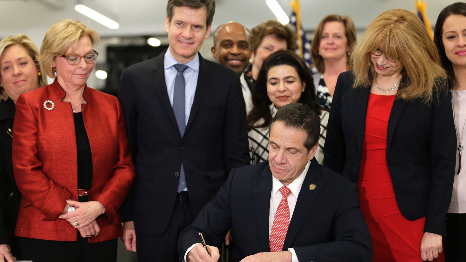 New York Gov. Andrew Cuomo, center, signs the Child Victims Act in New York, Thursday, Feb. 14, 2019. Cuomo has signed into law long-sought legislation that extends the statute of limitations so sexual abuse victims can have more time to seek criminal charges or file lawsuits. (AP Photo/Seth Wenig)