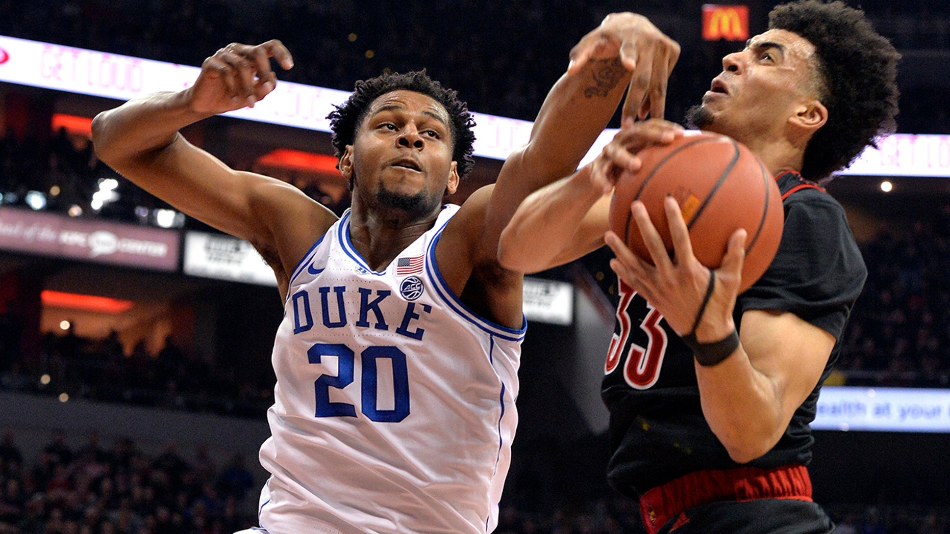 Duke center Marques Bolden (20) and Louisville forward Jordan Nwora (33) vie for a rebound during the first half of an NCAA college basketball game in Louisville, Ky., Tuesday, Feb. 12, 2019. (Associated Press)