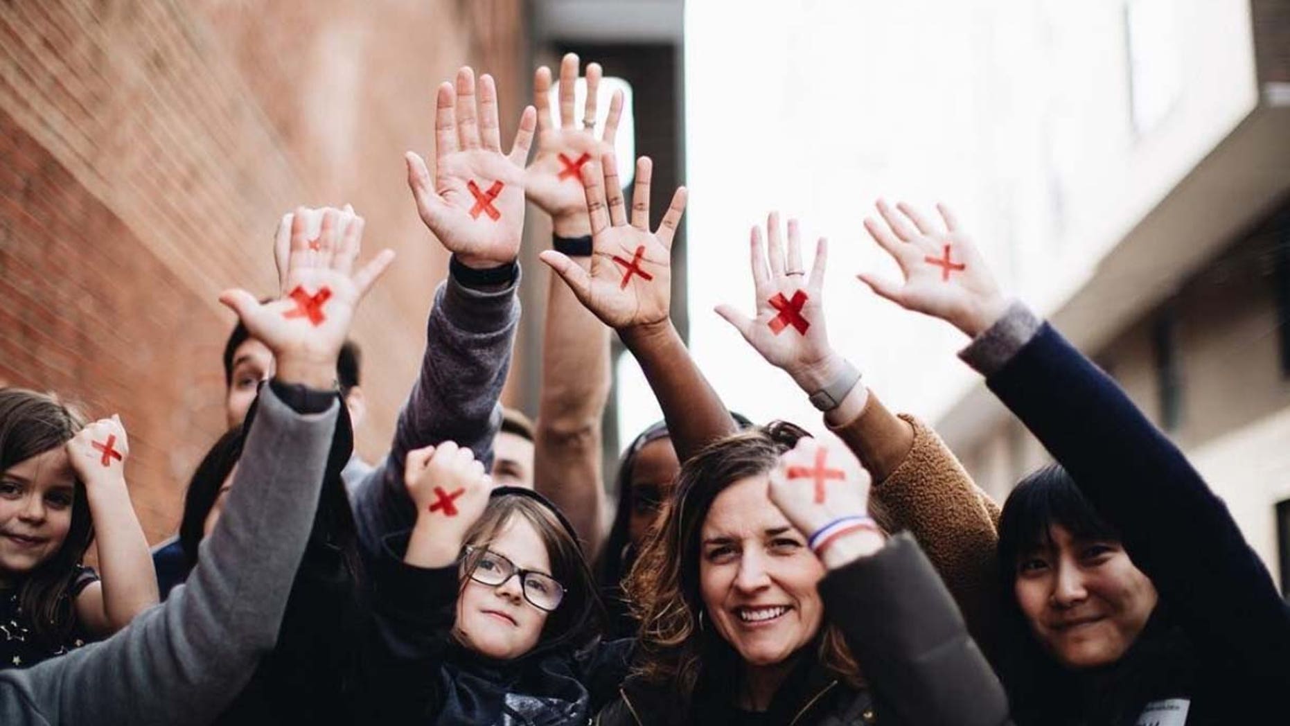 People put a red X on their hand to raise awareness for the "End It Movement," in an effort to end modern-day slavery.