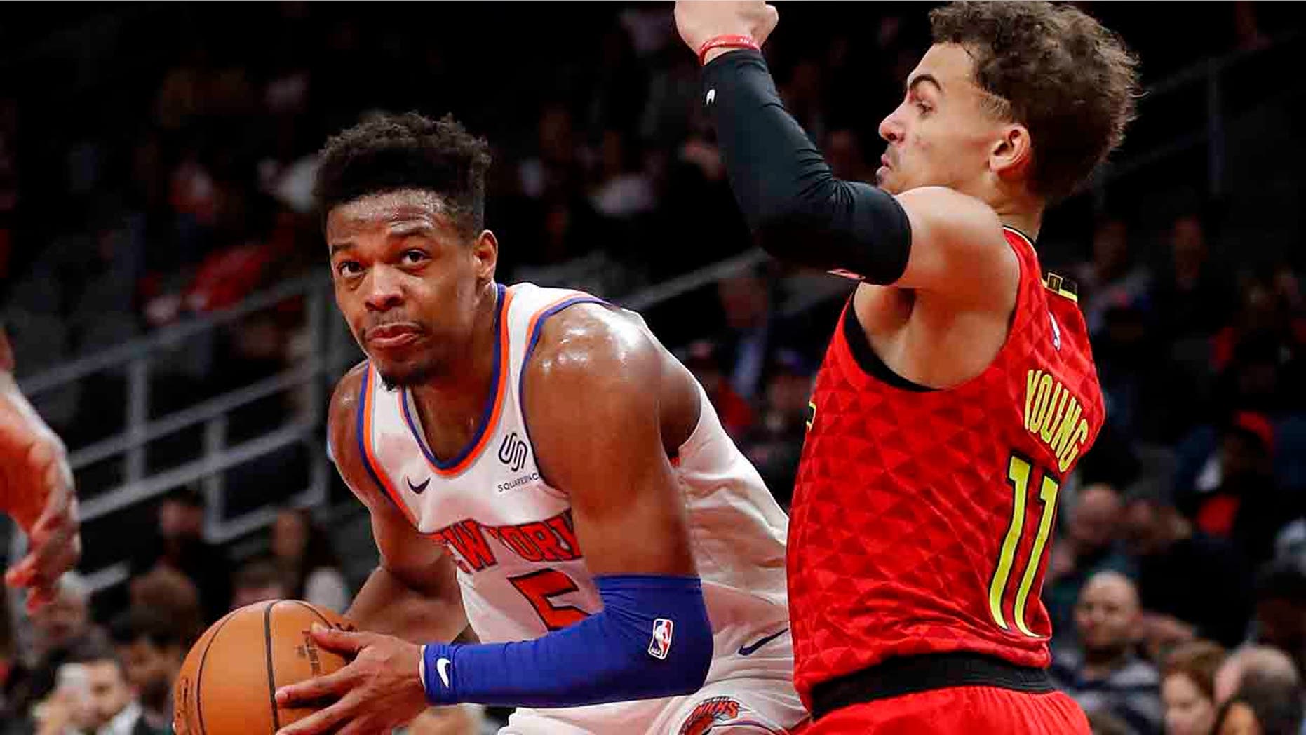 New York Knicks guard Dennis Smith Jr. (5) works against Atlanta Hawks guard Trae Young (11) during the second half of an NBA basketball game Thursday, Feb. 14, 2019, in Atlanta. New York won 106-91. (Associated Press)