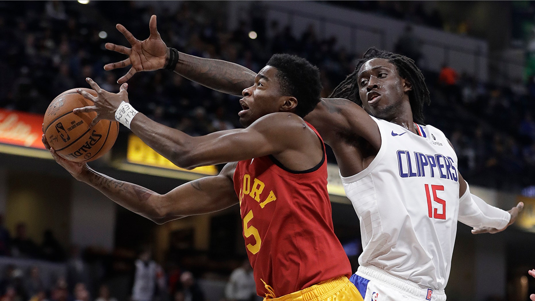 Indiana Pacers' Edmond Sumner shoots next to Los Angeles Clippers' Johnathan Motley during the second half of an NBA basketball game Thursday, Feb. 7, 2019, in Indianapolis. Indiana won 116-92.