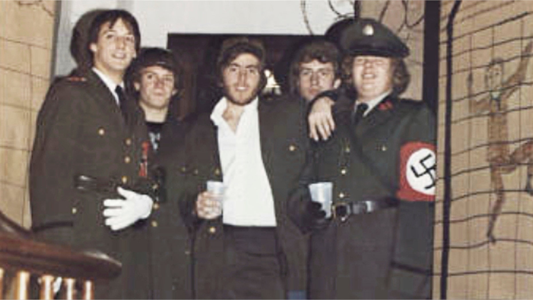 In this photo from the 1980 edition of Spectrum, the Gettysburg College Yearbook, Bob Garthwait, right, wears a suit that represents a Nazi uniform at a fraternity party. Garthwait, a funder and college administrator, apologized and announced his resignation from the board of directors on Tuesday, February 19, 2019. (Spectrum / Gettysburg College via AP)