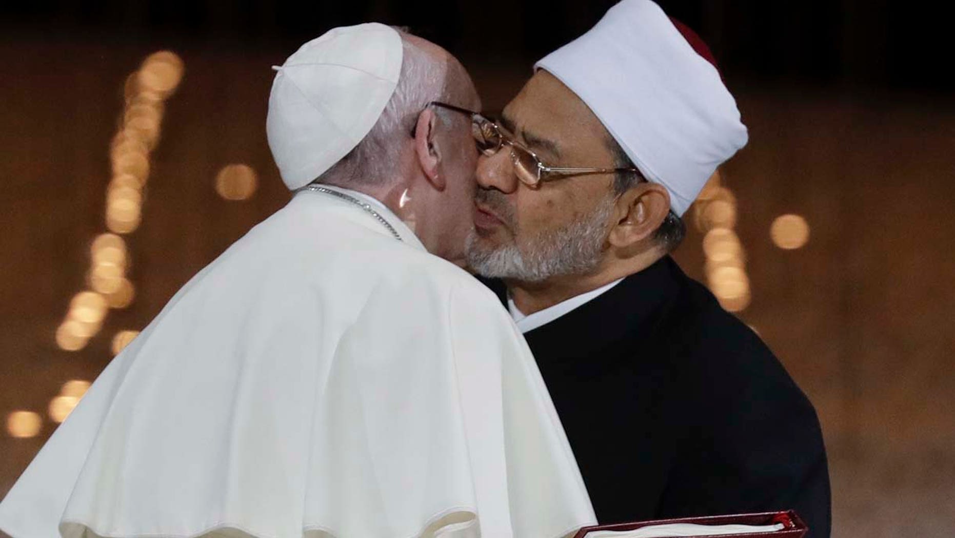 Pope Francis hugs Sheikh Ahmed el-Tayeb, the grand imam of Egypt's Al-Azhar, after an Interreligious meeting at the Founder's Memorial in Abu Dhabi, United Arab Emirates, Monday, Feb. 4, 2019. Pope Francis has asserted in the first-ever papal visit to the Arabian Peninsula that religious leaders have a duty to reject all war and commit themselves to dialogue. (AP Photo/Andrew Medichini)