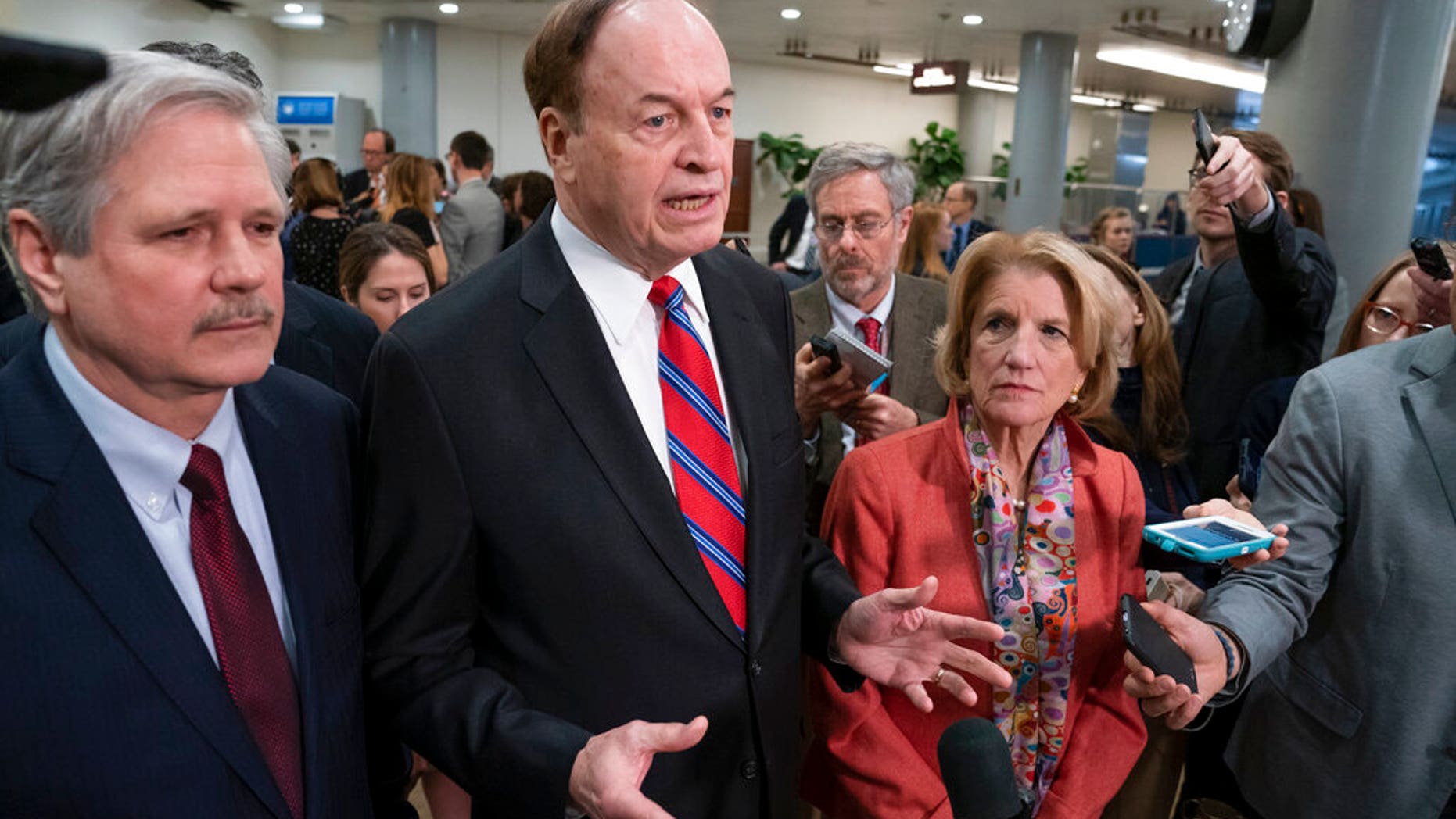 In this Feb. 6, 2019, photo, Sen. Richard Shelby, R-Ala., the top Republican on the bipartisan group bargainers working to craft a border security compromise in hope of avoiding another government shutdown, is joined by Sen. John Hoeven, R-N.D., left, and Sen. Shelley Moore Capito, R-W.Va., right, as they speak with reporters in Washington. (AP Photo/J. Scott Applewhite)