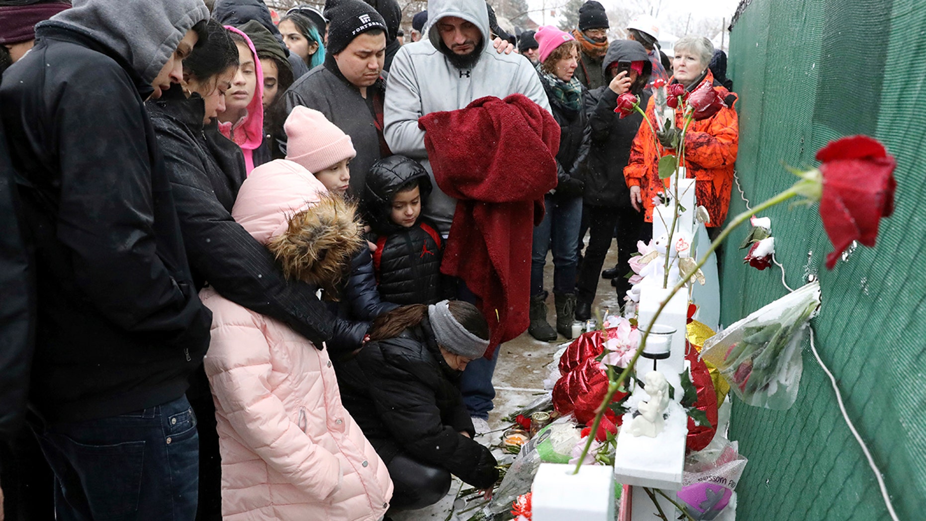 A Victim's family, Vicente Juarez, prayed Sunday at a makeshift memorial in Aurora, Illinois, near the manufacturing company Henry Pratt, where several people were killed on Friday. (AP Photo / Nam Y. Huh)