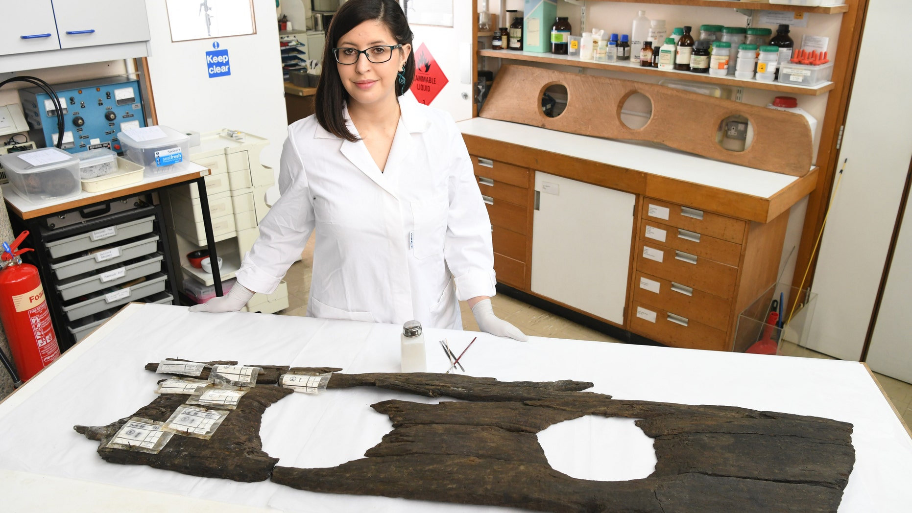 Conservator Luisa Duarte works on the 12th-century triple toilet seat, before it goes on display as part of the Museum of London Docklands Secret Rivers exhibition.