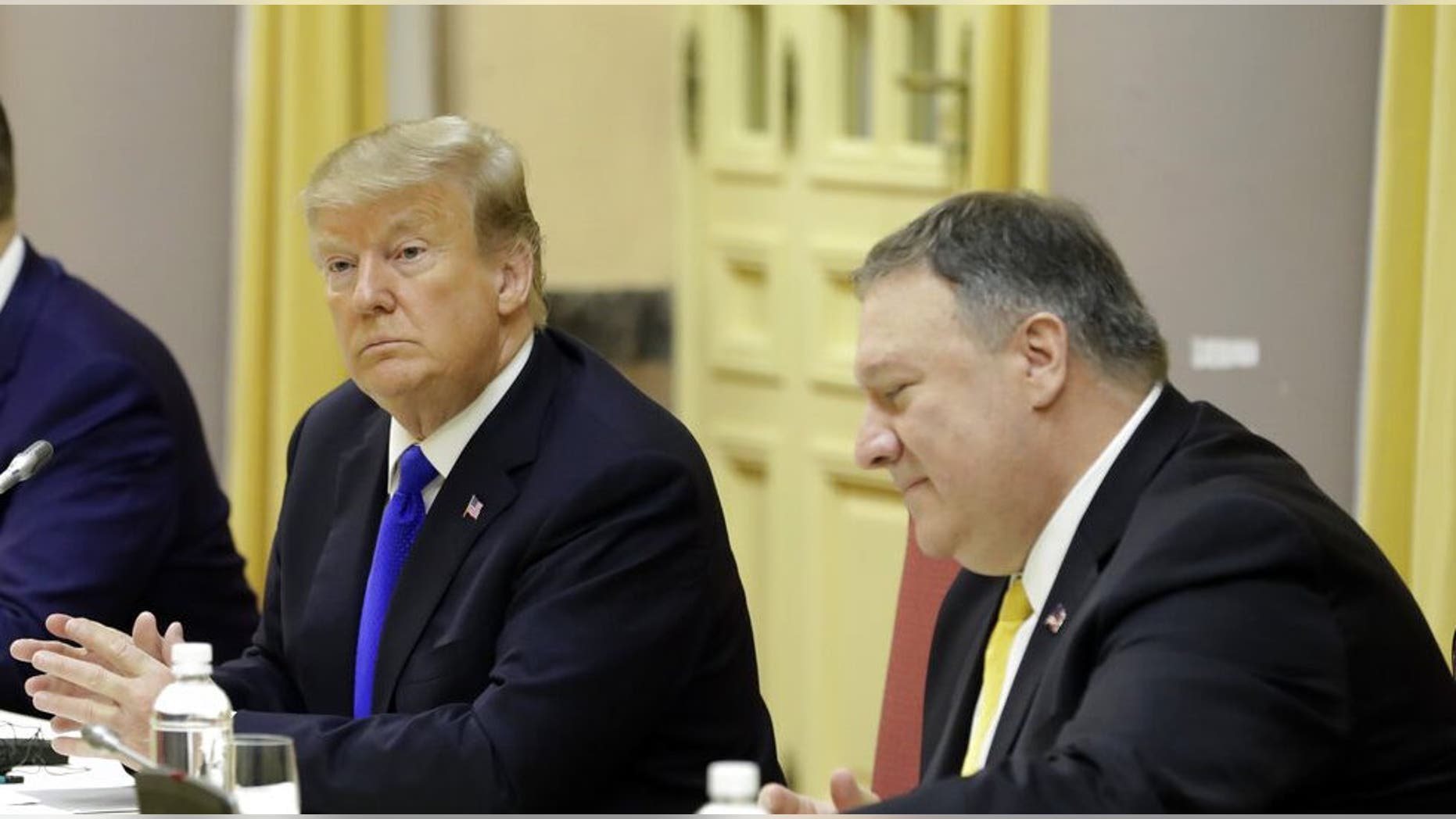 President Donald Trump and Secretary of State Mike Pompeo listen as they meet with Vietnamese President Nguyen Phu Trong at the Presidential Palace, Wednesday, Feb. 27, 2019, in Hanoi. (AP Photo/Evan Vucci)