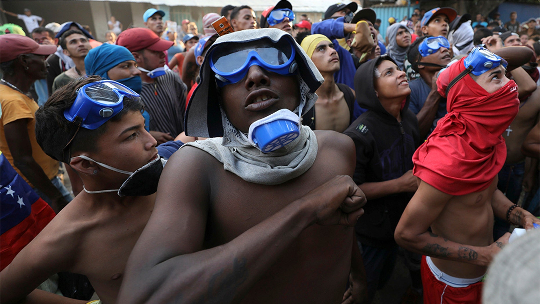 Venezuelan migrants under the Simon Bolivar International Bridge plead for people to support them with food and water so they can continue protesting in La Parada near Cucuta, Colombia, Sunday, on the border with Venezuela. (AP Photo/Fernando Vergara)