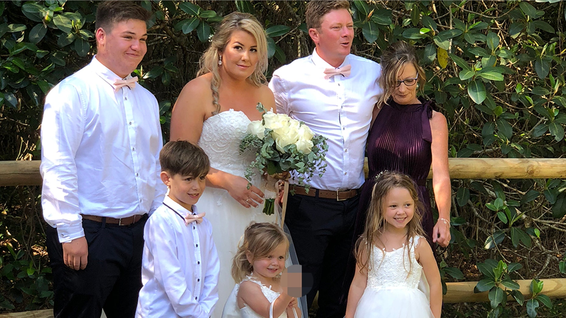 (Pictured: l-r Ashton,15, Tyler,8, Hannah,31, Maddison,3, Nathan,31. Halle,5, and mother in law Louise) - A mortified mom was left red-faced after her cheeky little girl hilariously popped the middle finger up during a family photoshoot on her wedding day.