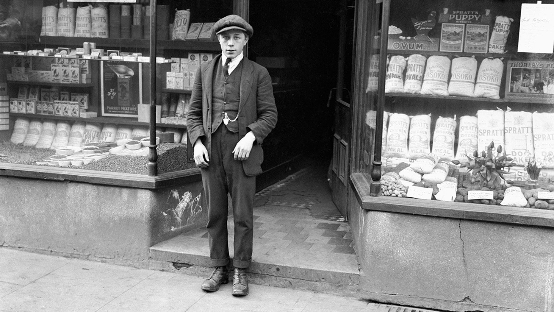 The accused, 15-year-old Harold Jones, was tried and acquitted of Freda's murder and went on to kill Florie Little within a few weeks of his release. Pictured is the accused boy at the time of the inquest into Freda Burnell's murder, standing outside Mortimer's Corn Stores in Somerset Street where he was working when the young girl entered, on an errand for her father. 9th February 1921. (Photo by Daily Mirror/Mirrorpix/Mirrorpix via Getty Images)