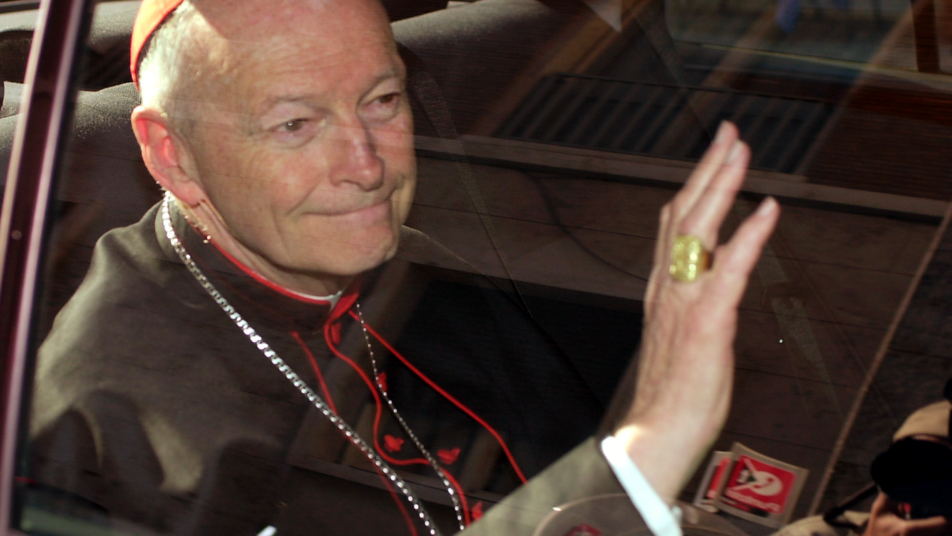 FILE - In this April 23, 2002 file photo Cardinal Theodore McCarrick of the Archdiocese of Washington, waves as he arrives at the Vatican in a limousine. On Saturday, Feb. 16, 2019 the Vatican announced Pope Francis defrocked former U.S. Cardinal Theodore McCarrick after Vatican officials found him guilty of soliciting for sex while hearing Confession. (AP Photo/Andrew Medichini, file)