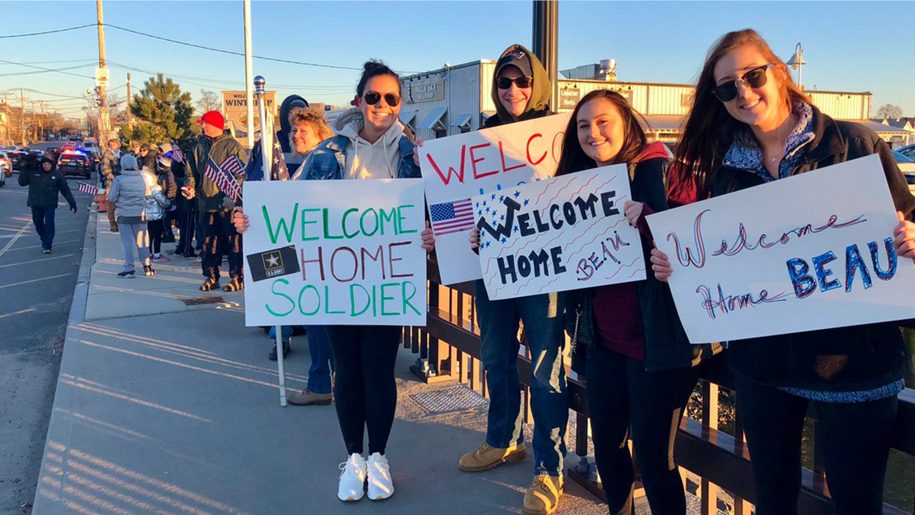 Dozens lined a bridge into Winthrop, Mass., Saturday to surprise U.S. Army soldier Beau Schlichting who returned home from a nine-month deployment in Afghanistan.
