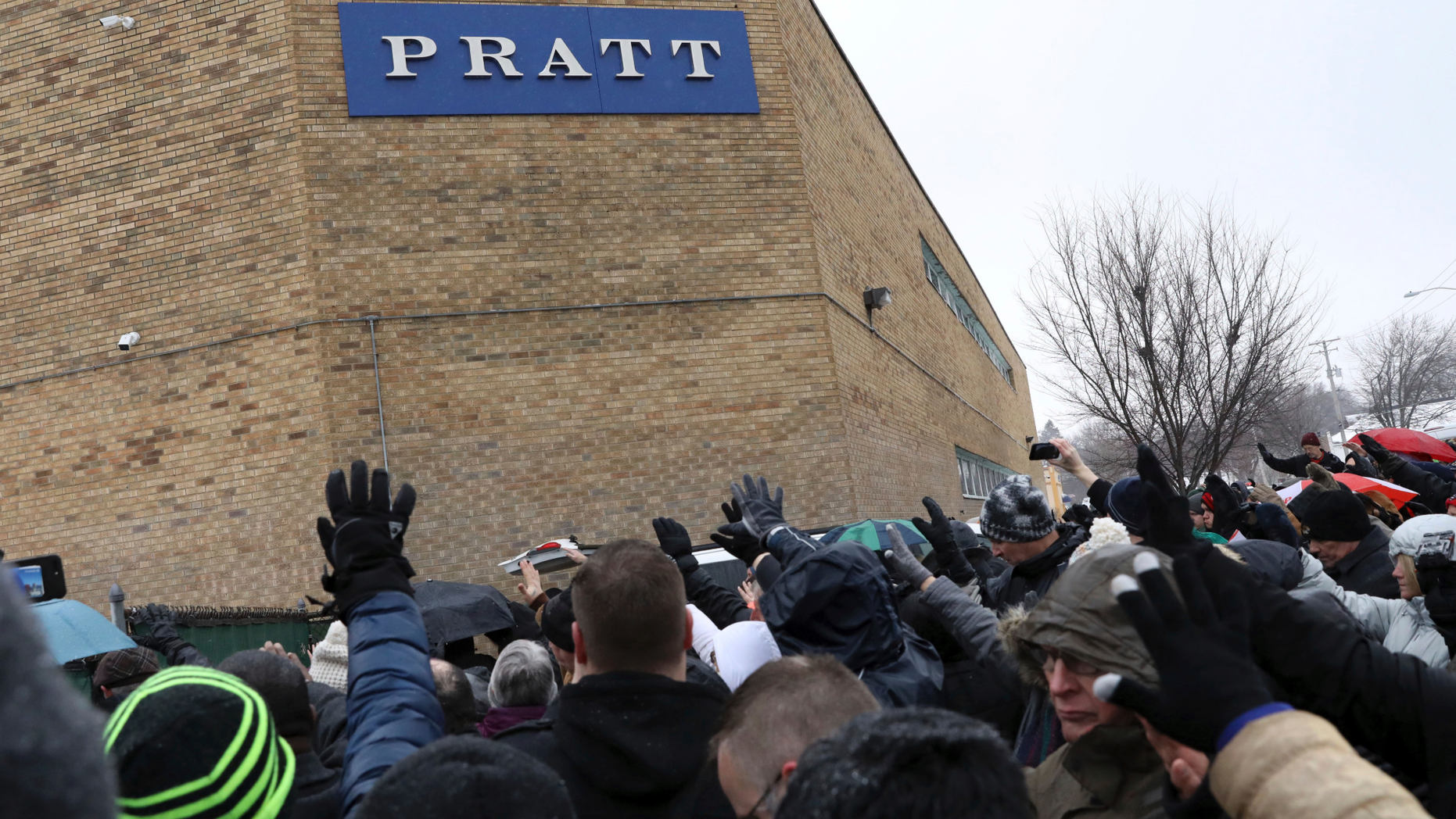 Family, friends and community members attend a vigil Sunday, Feb. 17, 2019, in Aurora, Ill. Six people, including a gunman, died in a shooting at a manufacturing warehouse in Aurora on Friday afternoon, and five officers were struck by gunfire. (AP Photo/Nam Y. Huh)